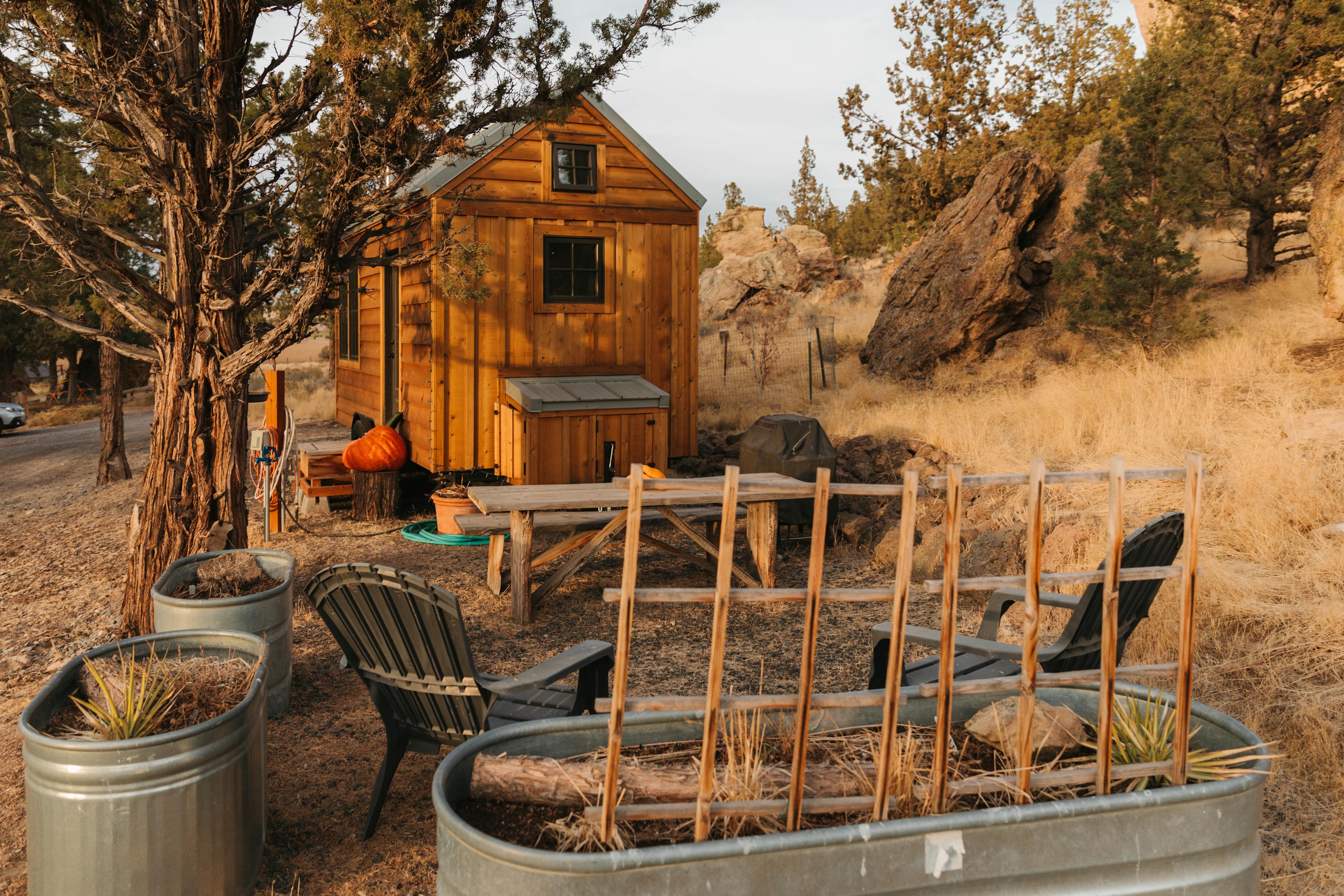 The tiny home and picnic area are situated at the base of the 300+ ft boulders