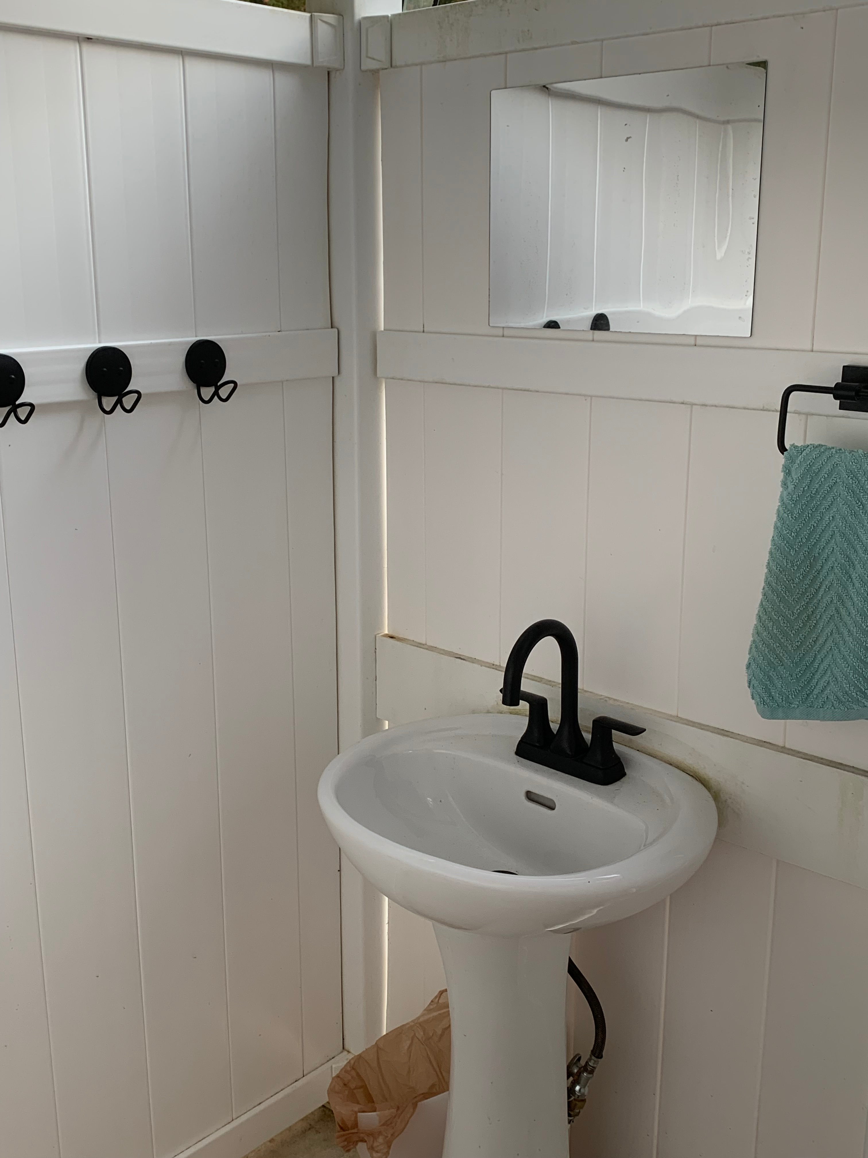 Sink in open air, outdoor bathroom. Cold water only.