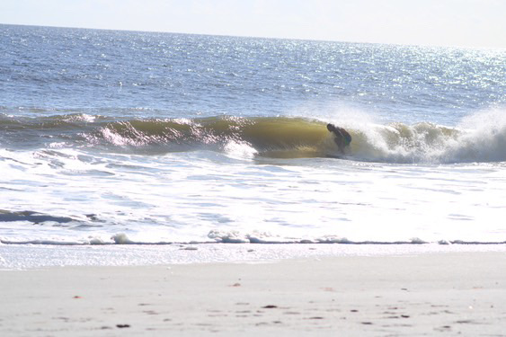 Surfing barrels at beach break 2 miles up the road