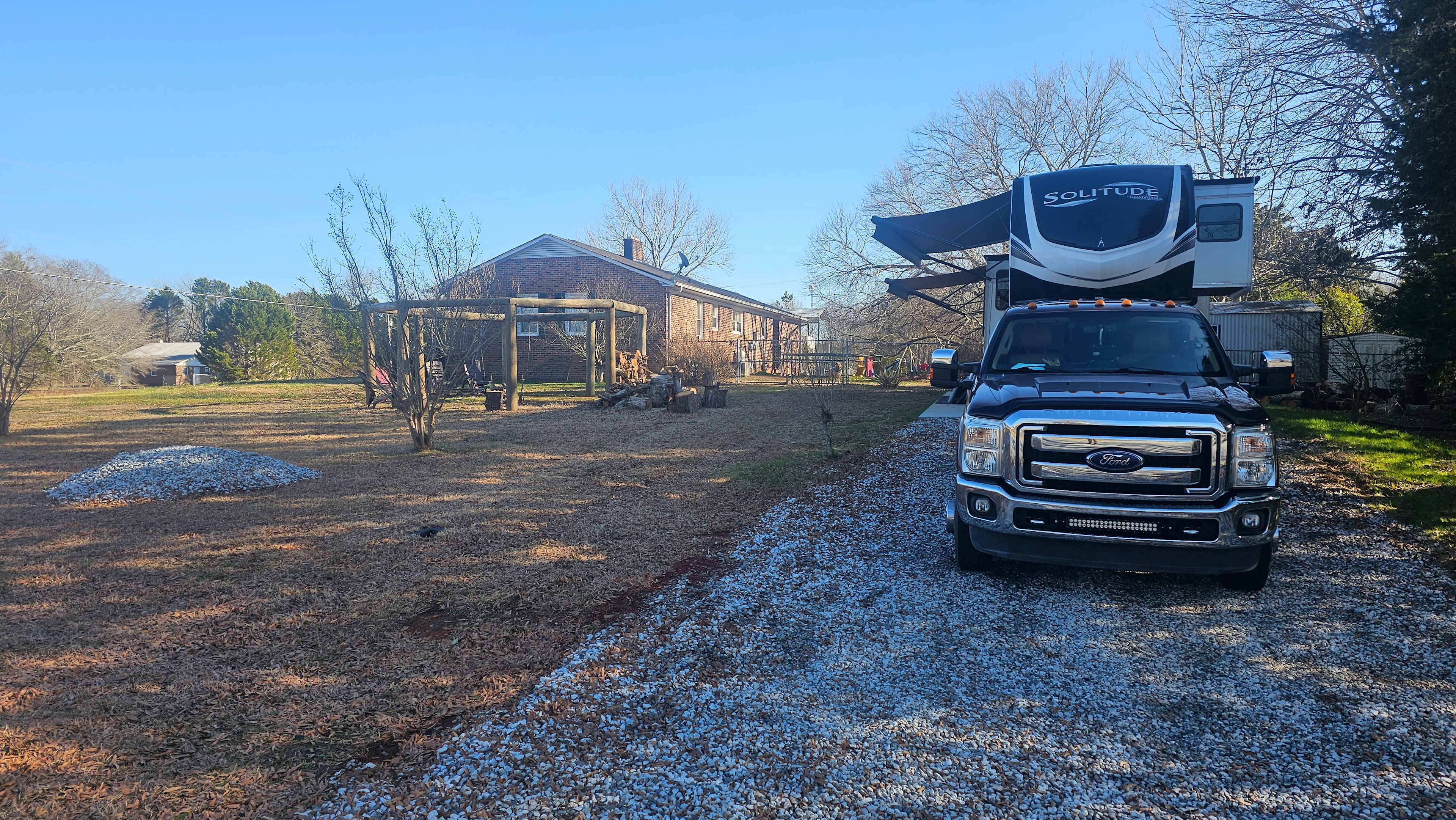 Packed gravel entry way to spot with ample space to back-in. 
