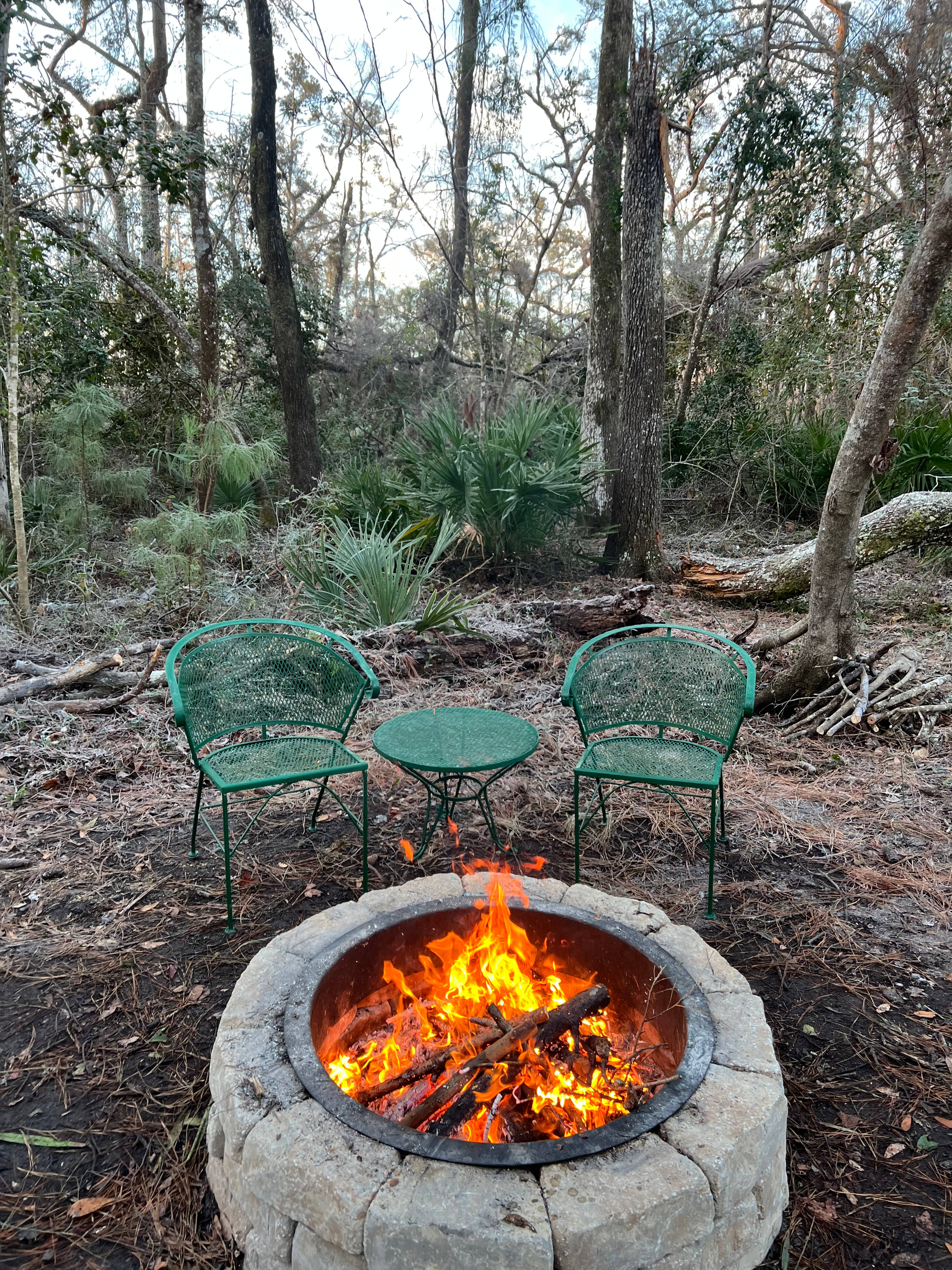 A fire pit with table and chairs are provided.