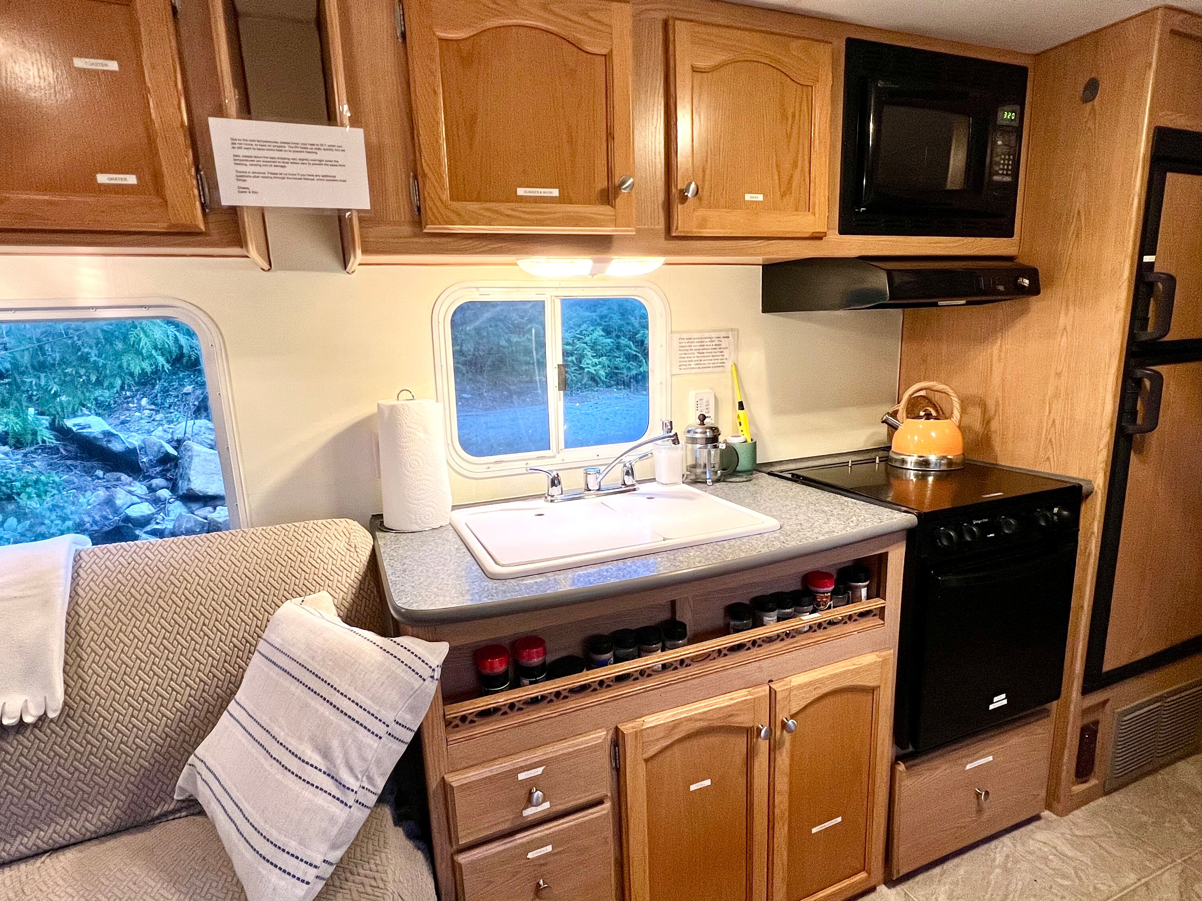 Clean kitchen has lots of storage space and a full fridge and freezer