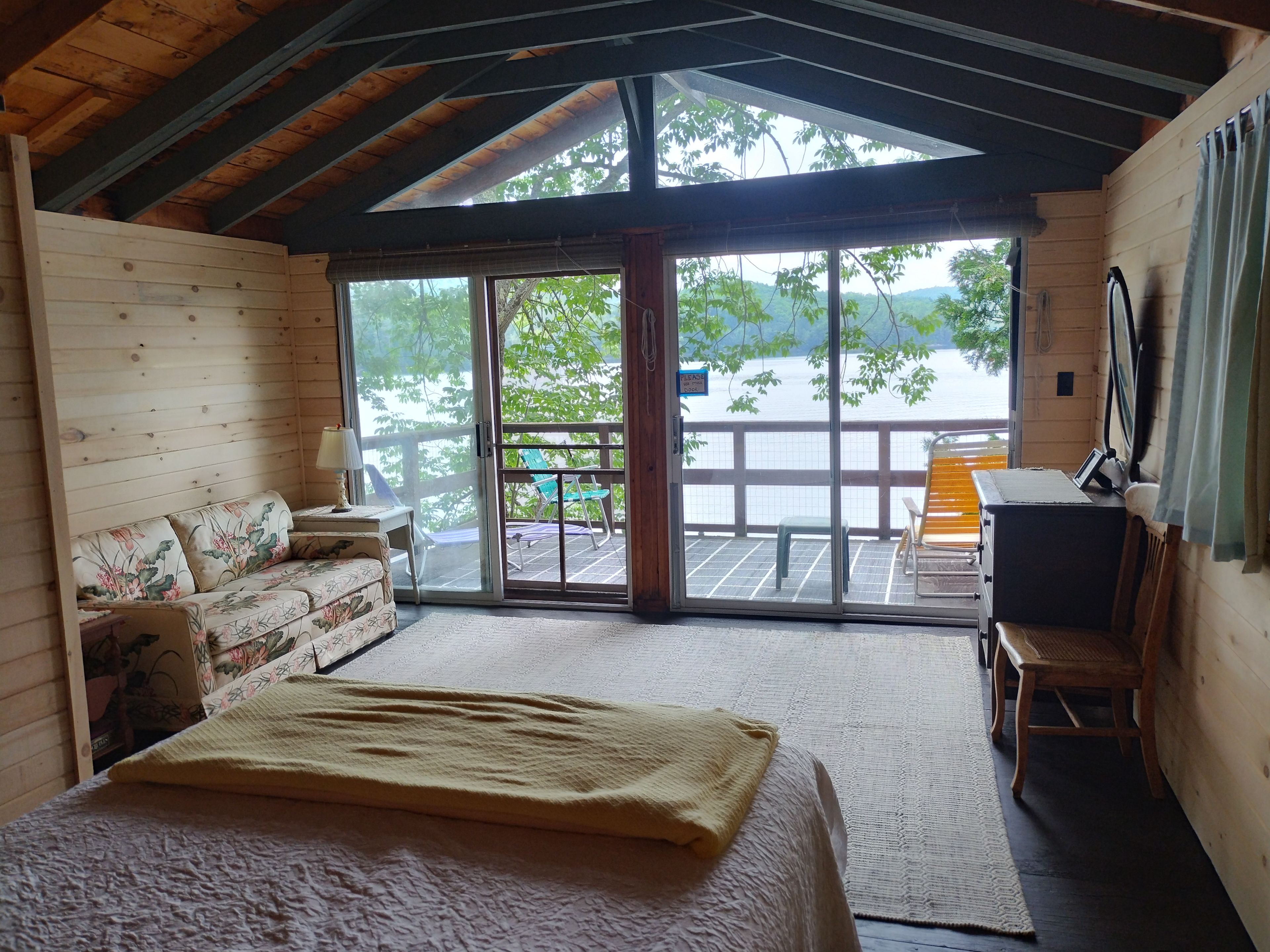 The bedroom and upper deck of Chickadee Cottage.  