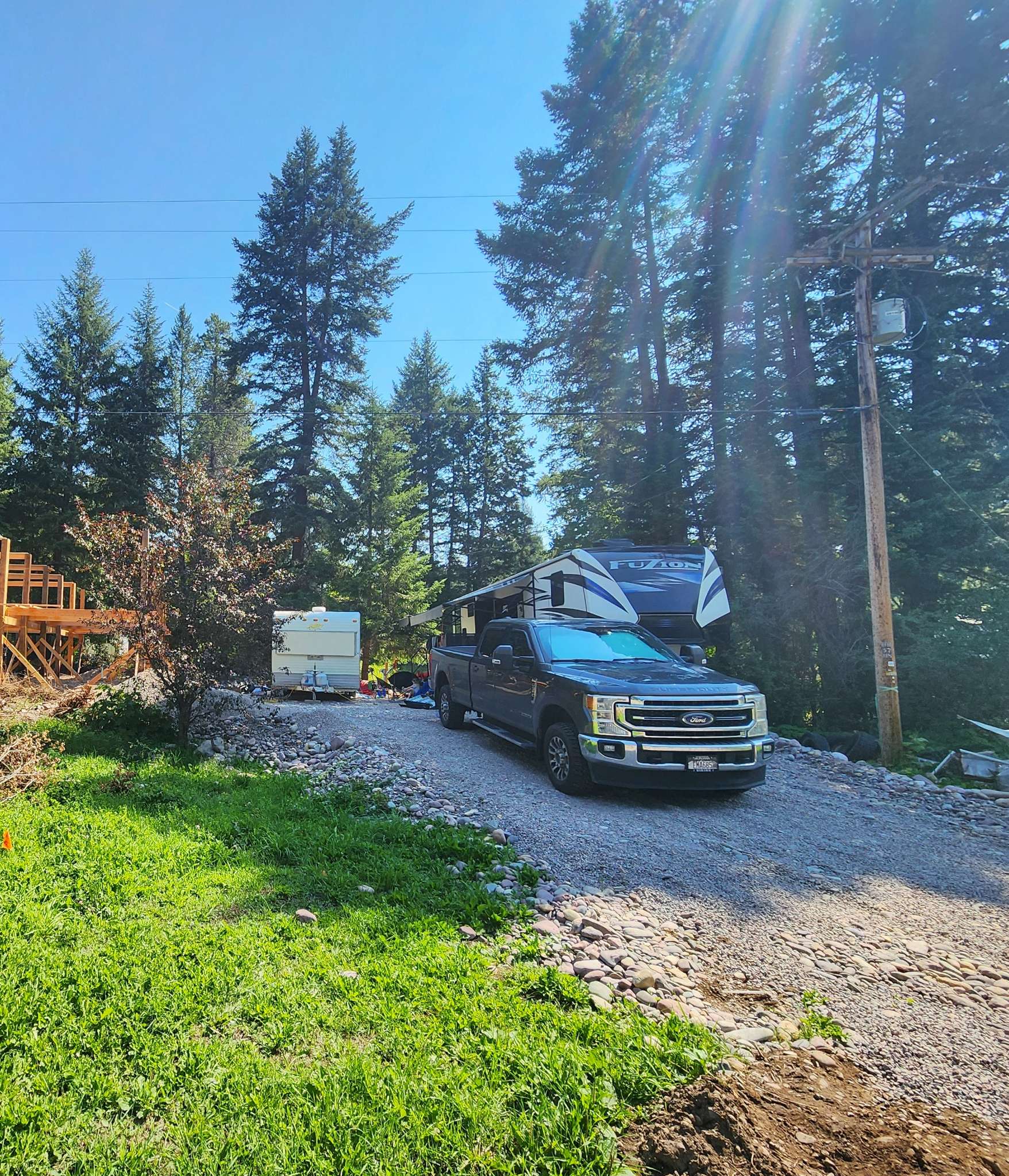 Occupied sites showing a 43ft ToyHauler (back and side patio out) 

Smaller range site with a 22ft camper (Fits up to 35ft)

The truck is parked in the middle of the driveway (perspective) 

The elevated river rock allows for excellent drainage during rainy days. 