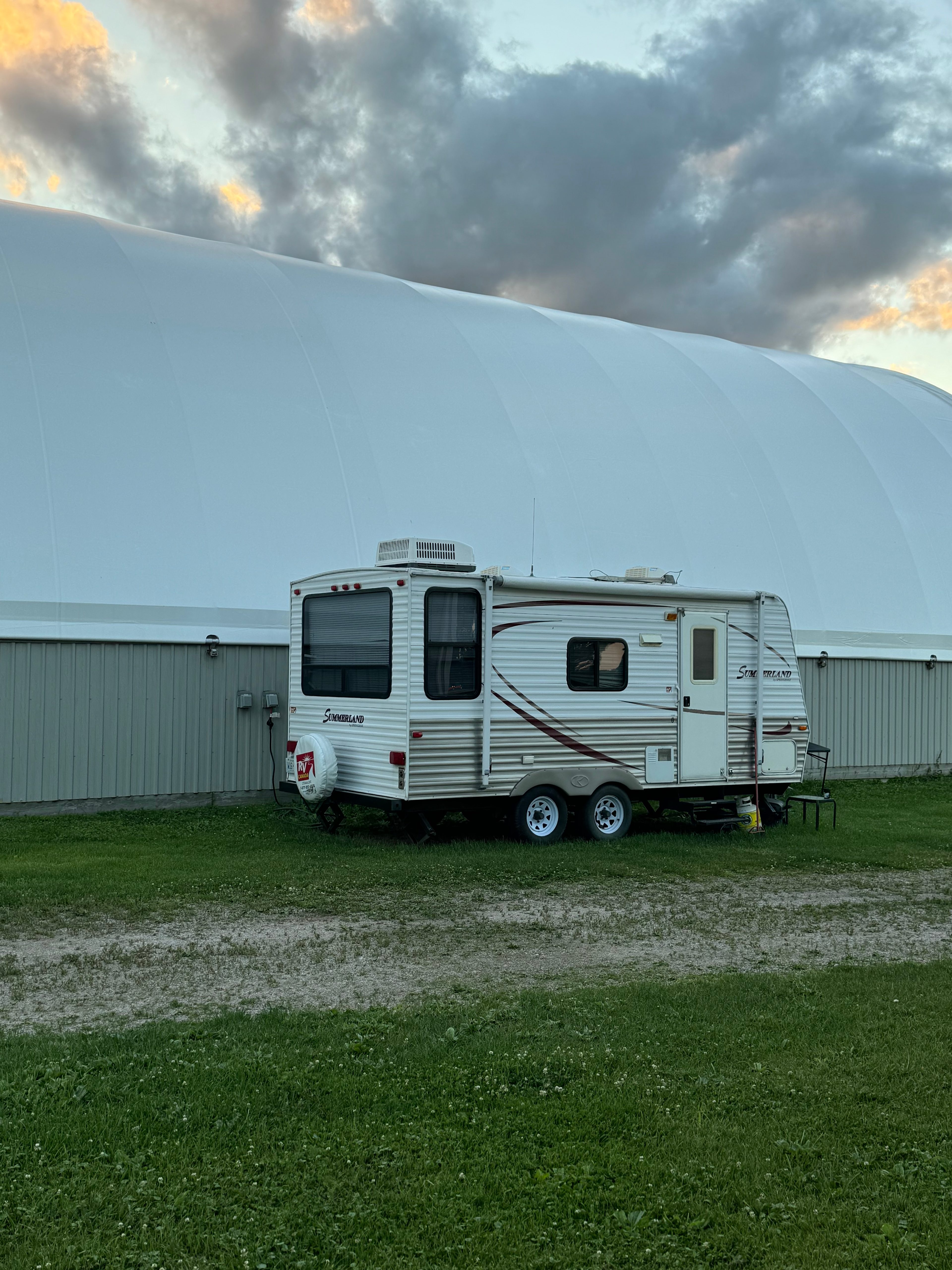 “Level RV parking with 30/50‑amp power right beside the coverall building.”