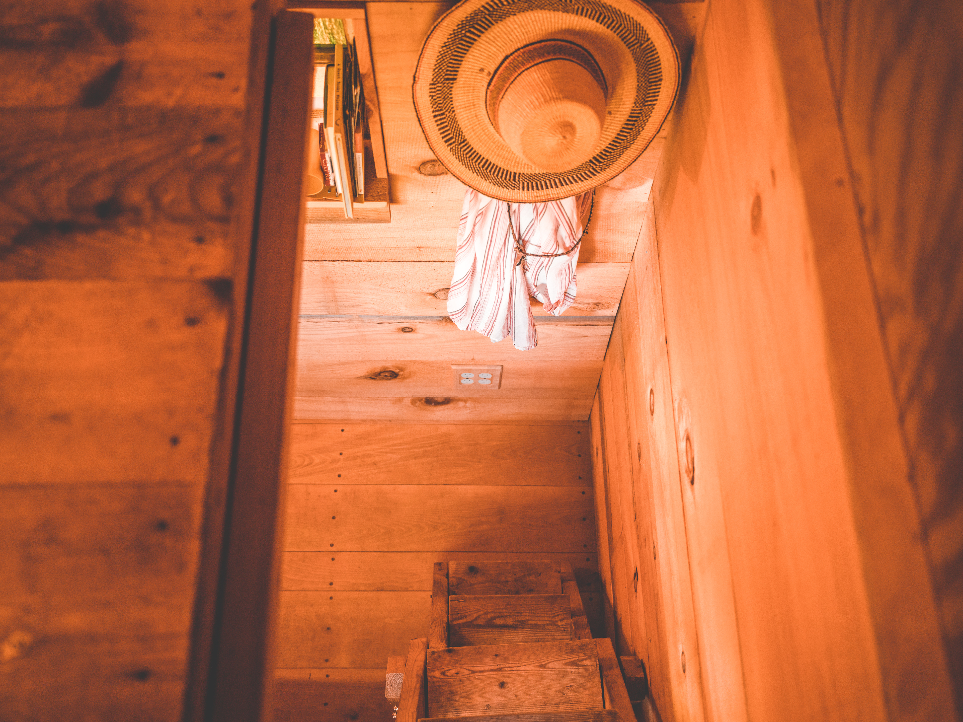 view from the upstairs bedroom area looking down. the door hatch can close and you can fold the mattress all the way out.