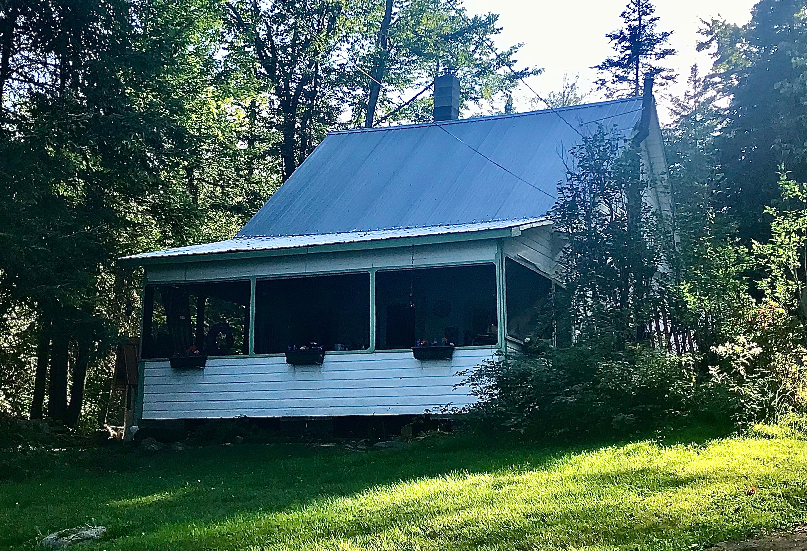 The cottage has a huge screen porch that overlooks the lake. Porch furnishings include a large table with seating (for meals, playing board games and cards), a vintage chaise lounge drops down as a cot if you want to sleep within open air, hammock, and rustic armchairs. 