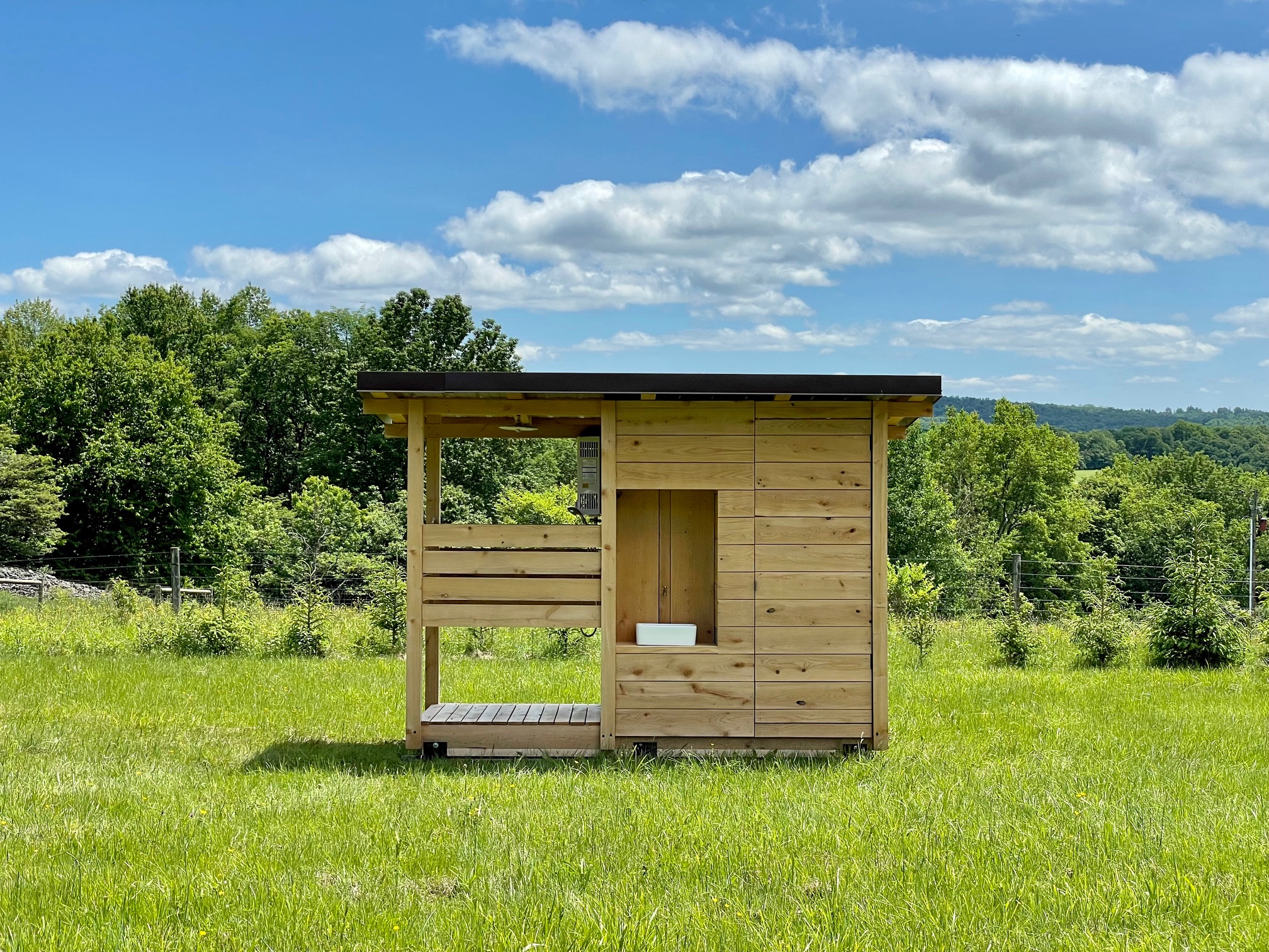 Wash station with hot shower, composting toilet and hand sink.