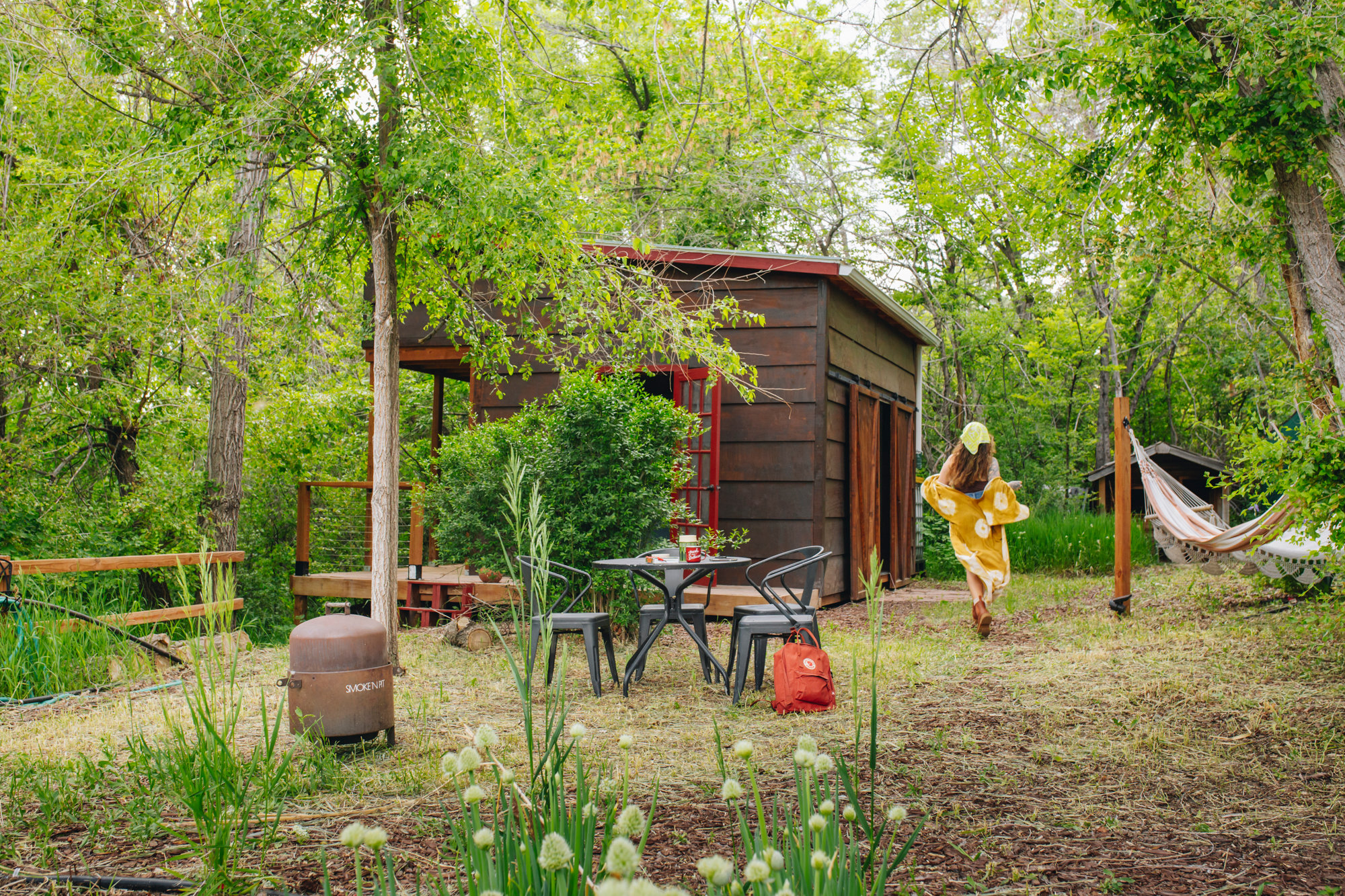 Outdoor table, hammocks and cabin