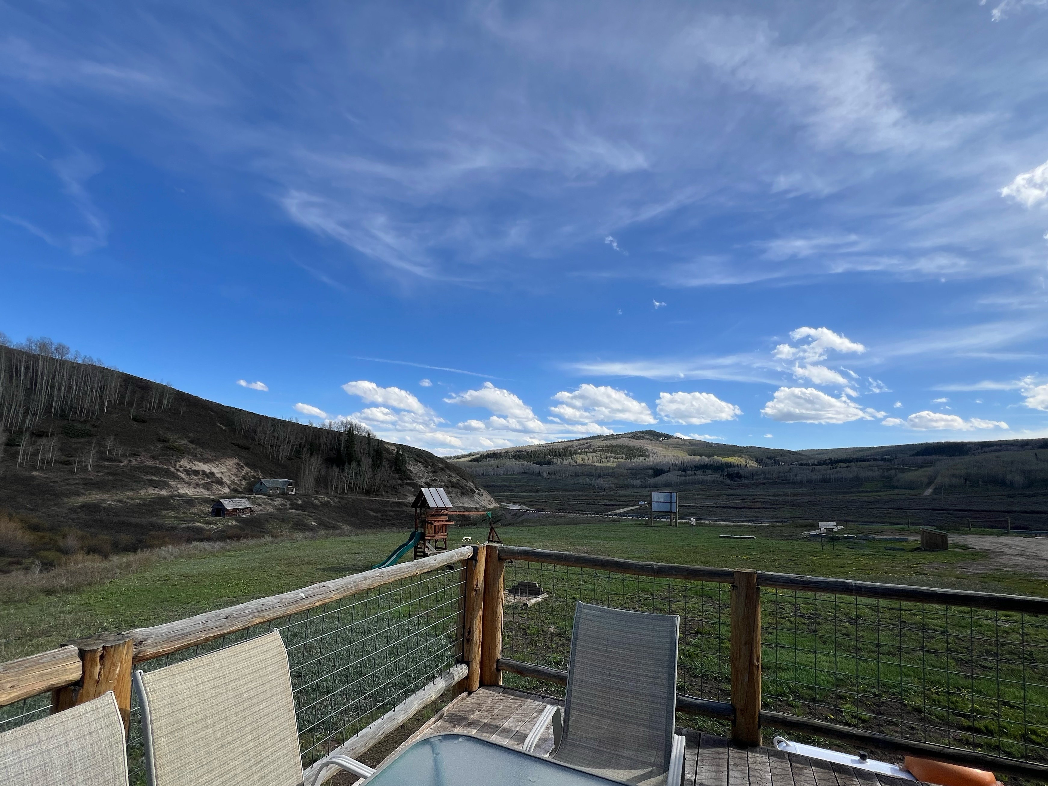 The deck of the Hitchin' Post has 360* views, a grill and access to the hot tub, horseshoes and playset for the kids.