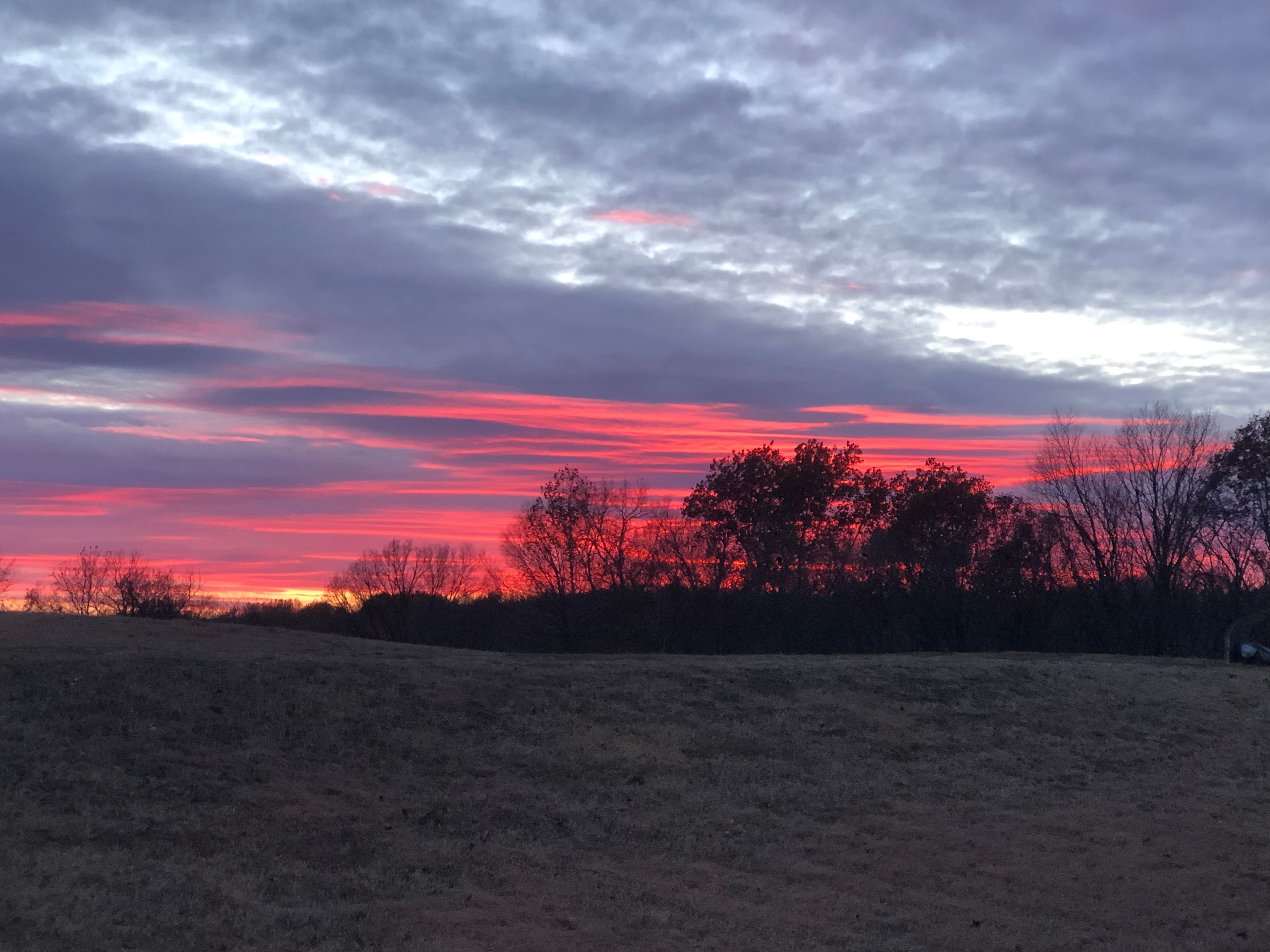 Evenings often end with peaceful sunsets and quiet skies over the open fields.
