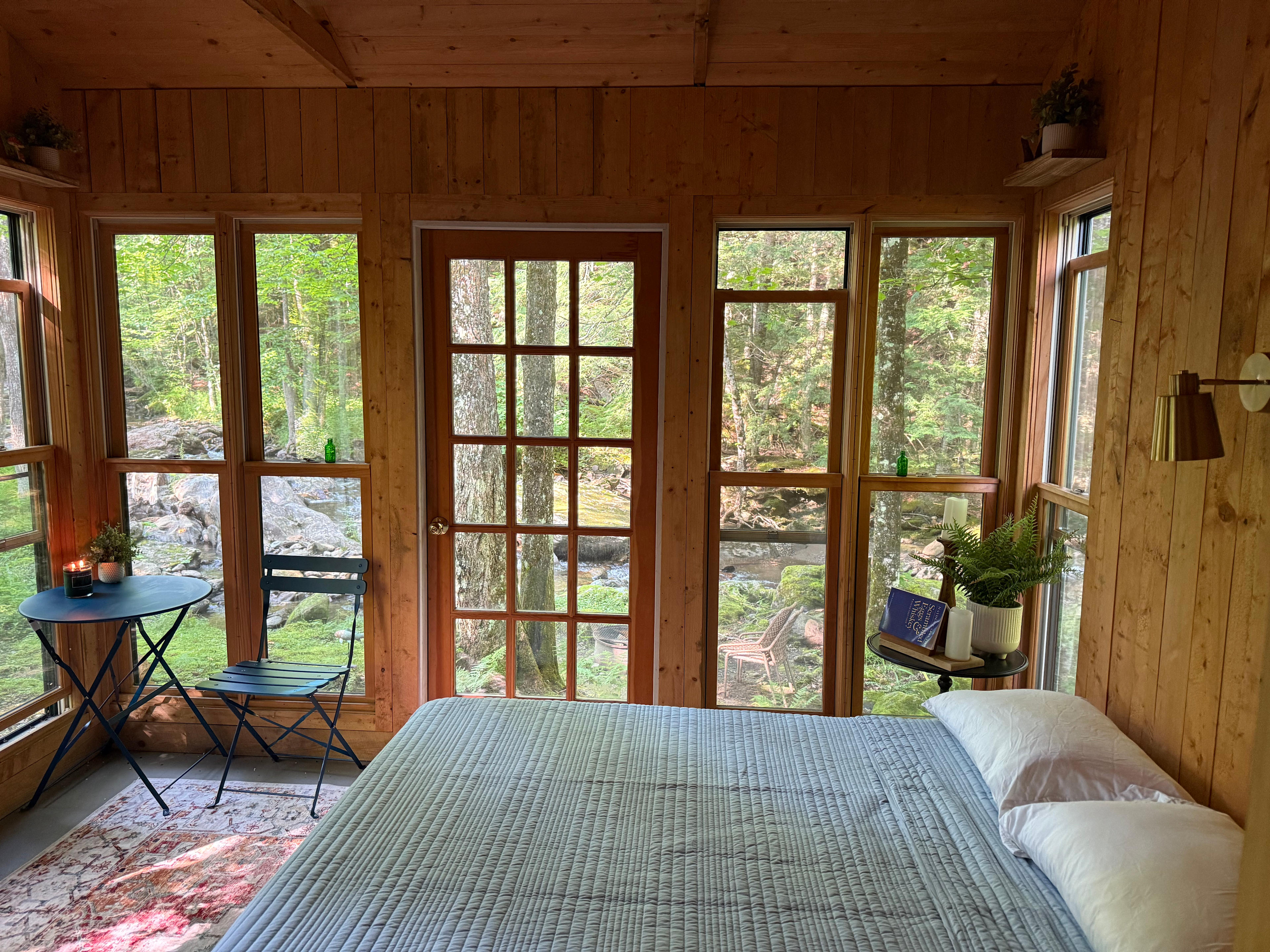 Waterside Views & Sounds
Several windows face the brook, filling the cabin with natural light and the soothing sounds of flowing water. Whether you’re sipping coffee at the bistro table or stretched out on the cozy bed the gentle murmur of Foote Brook is your constant, peaceful companion.