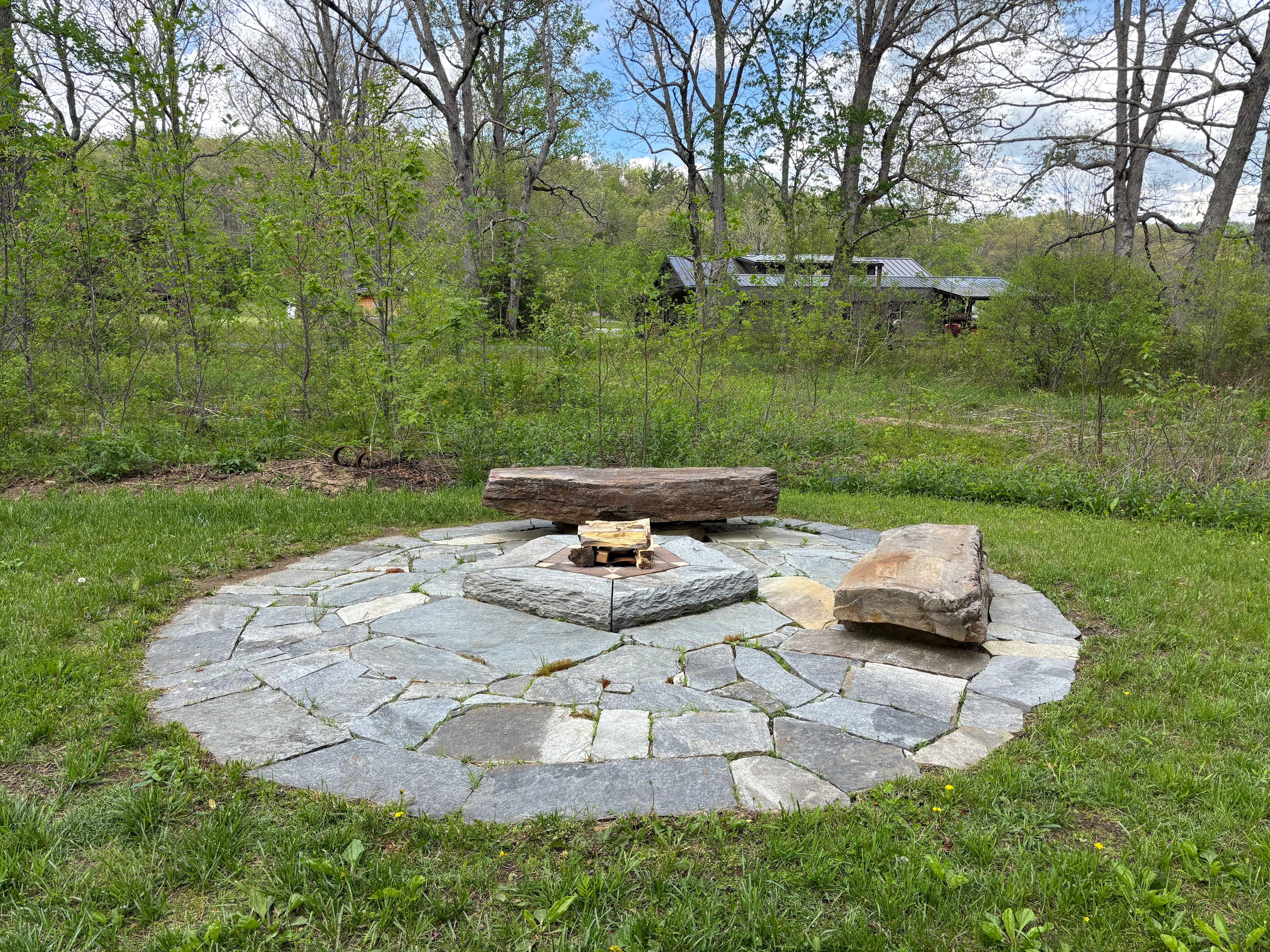 Stone fire circle.  We have firewood for sale by the garage (seen in the distance) near the parking area.