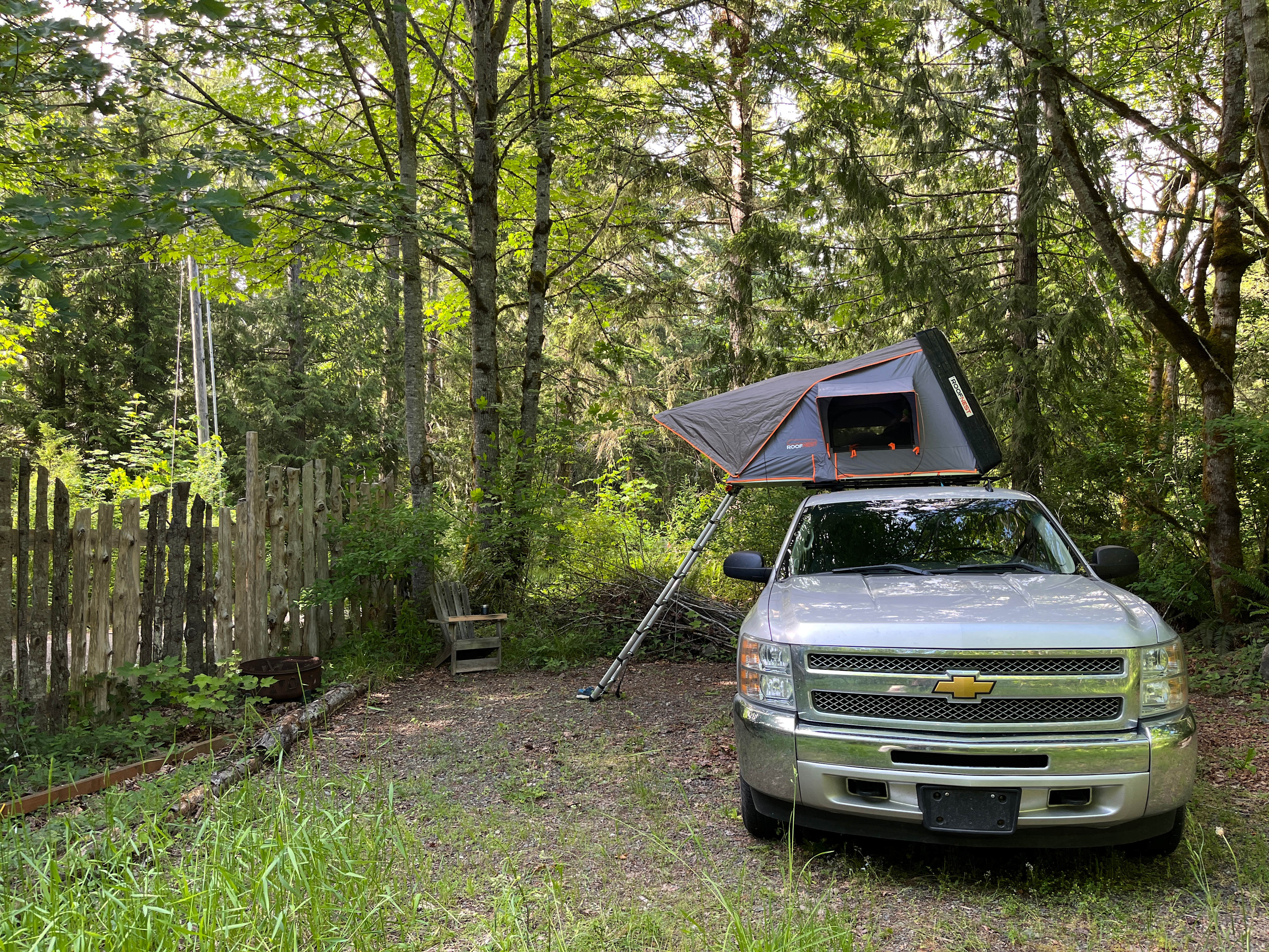 12'x25' parking for RV, van or car campers.  Site has slight grade and is gravel.  Communal outside kitchen and bathroom are about 500' from this area, via wooded path.