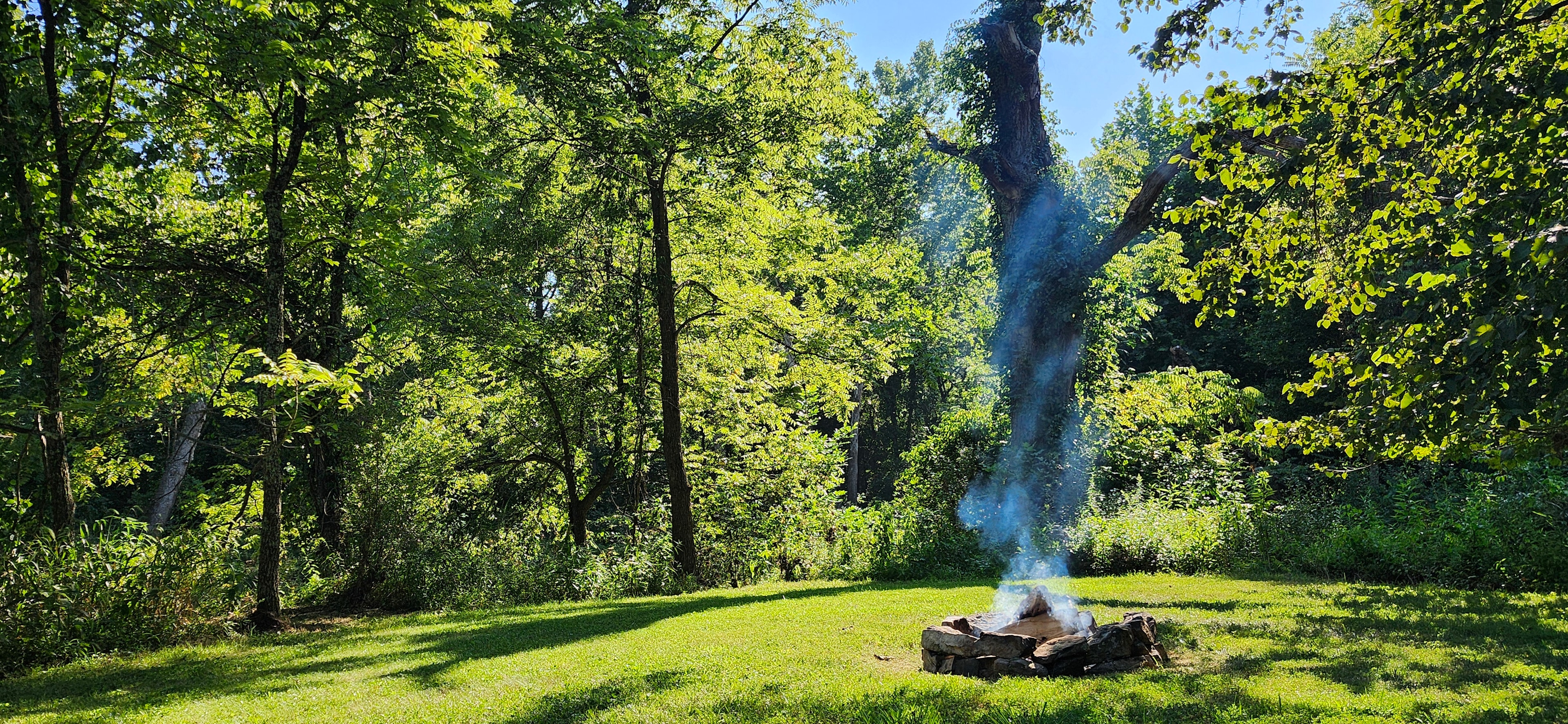 The fire-ring at the South End Tent Site.  This site offers great Creek views, fishing, and may be the most private Site we offer.