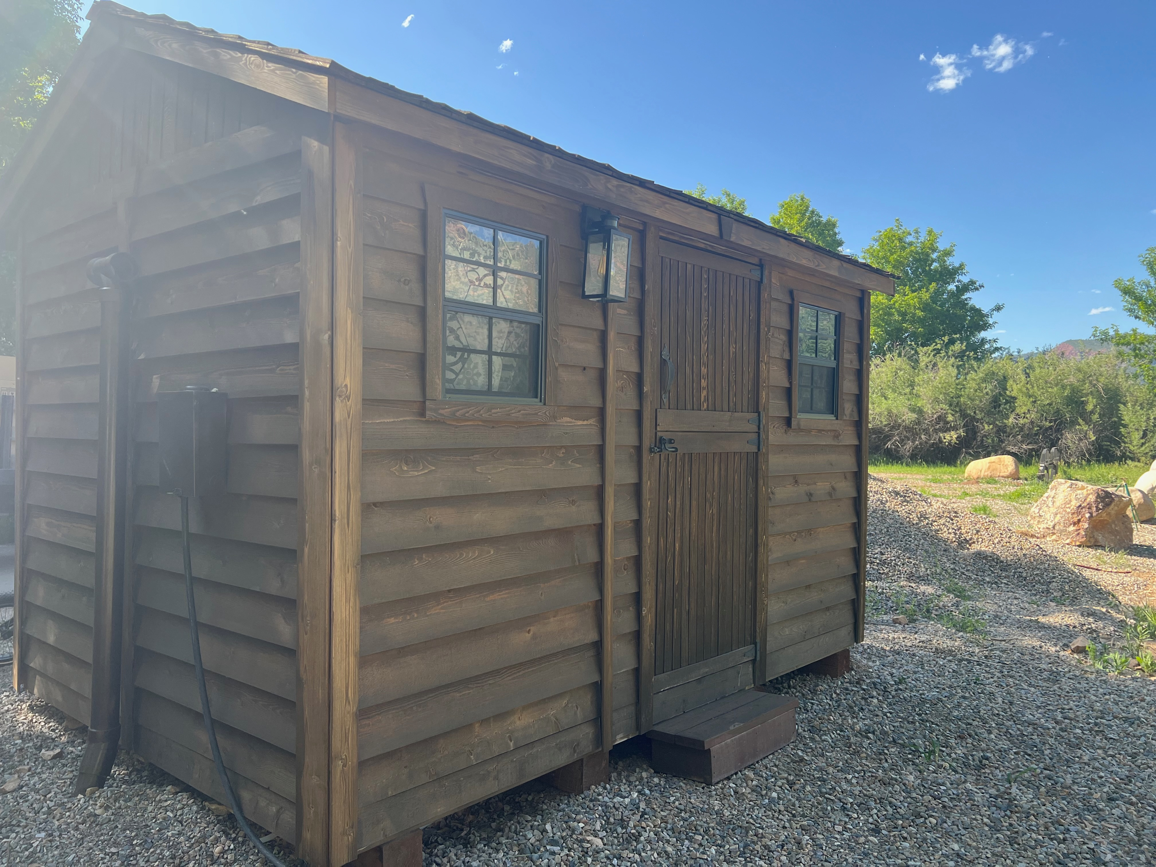 Bath house with 2 rooms, each with a hot shower, sink, and toilet