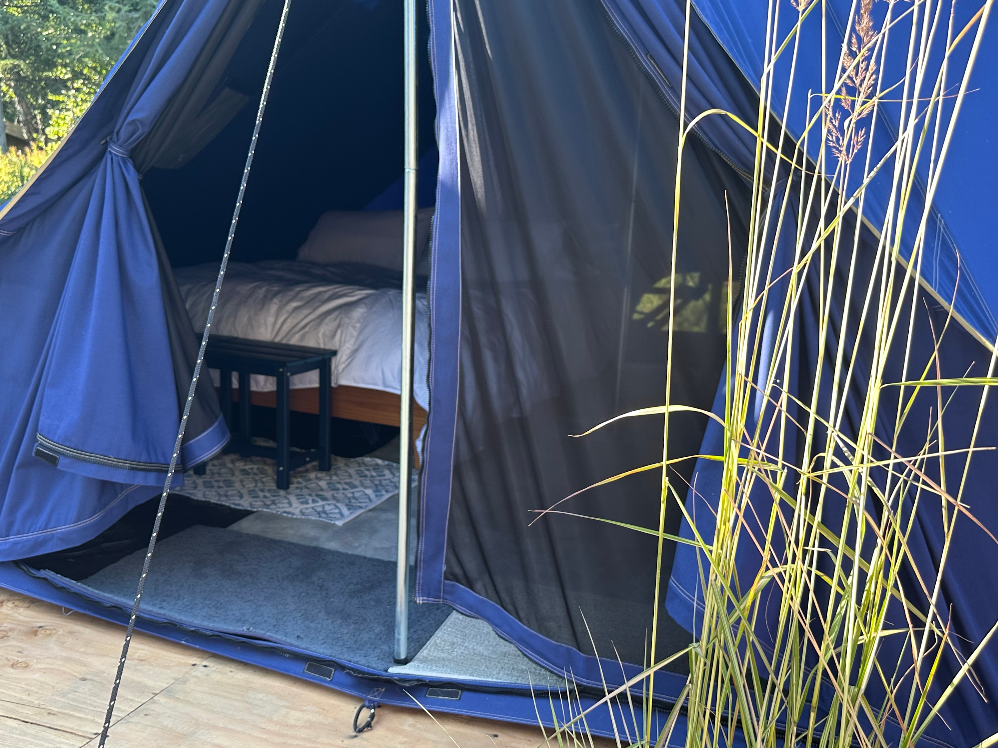 The decks are spacious plants everywhere with chairs a fire pit and picnic tables with huge umbrellas 