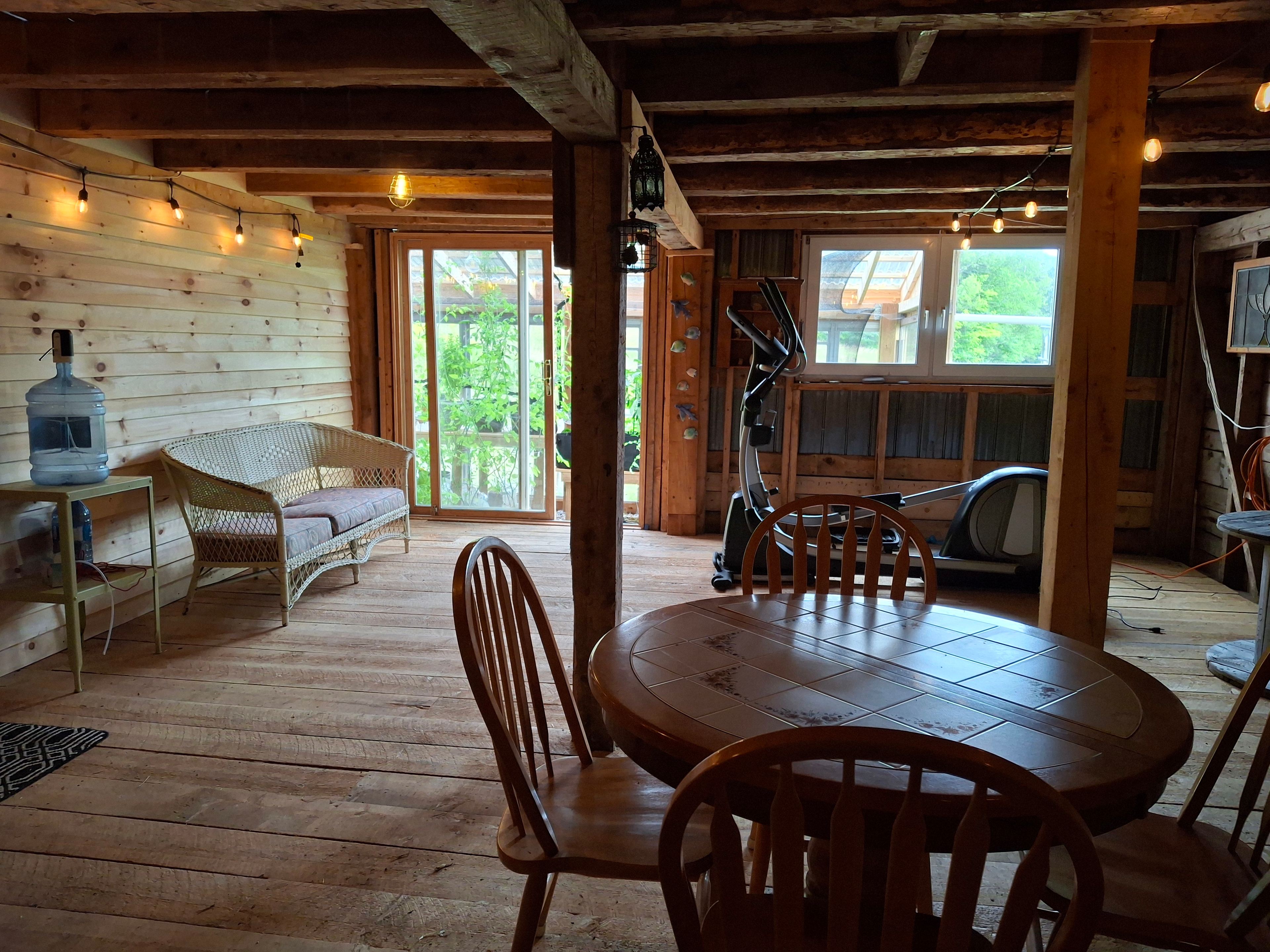 Indoor area in the barn, accessed through the greenhouse. Great for rainy days to eat your breakfast inside or play a game