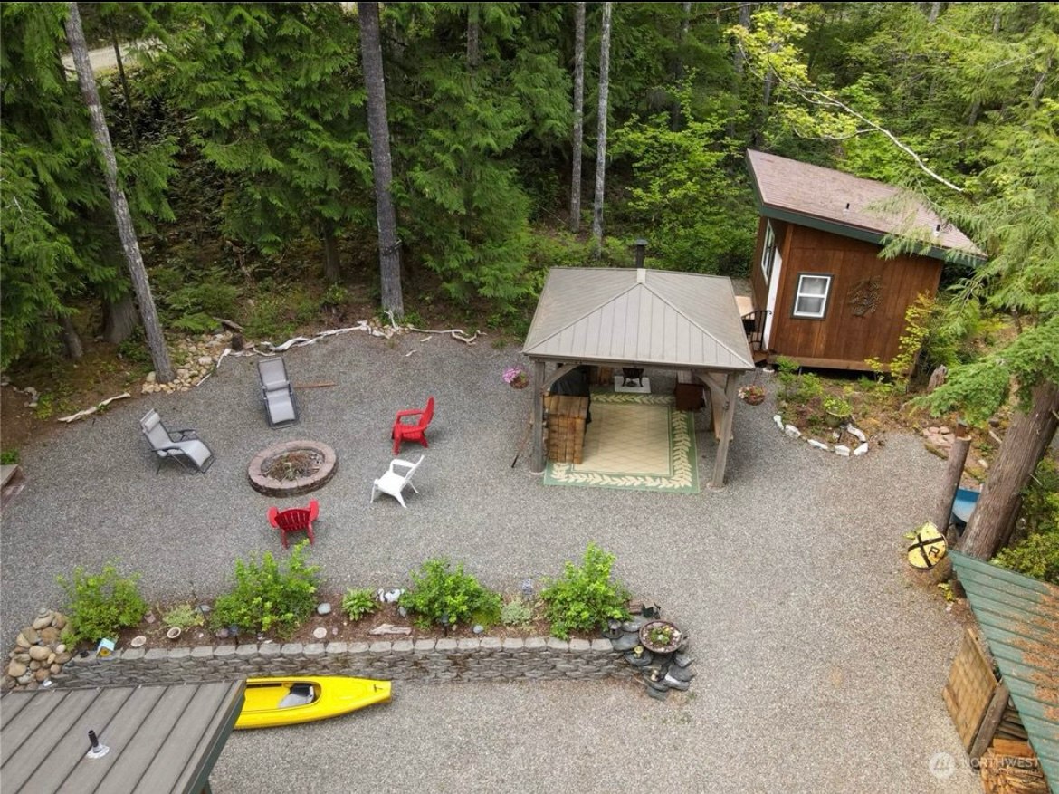Gazebo area and fire pit. Access to the creek is down a path behind the small cabin on the right