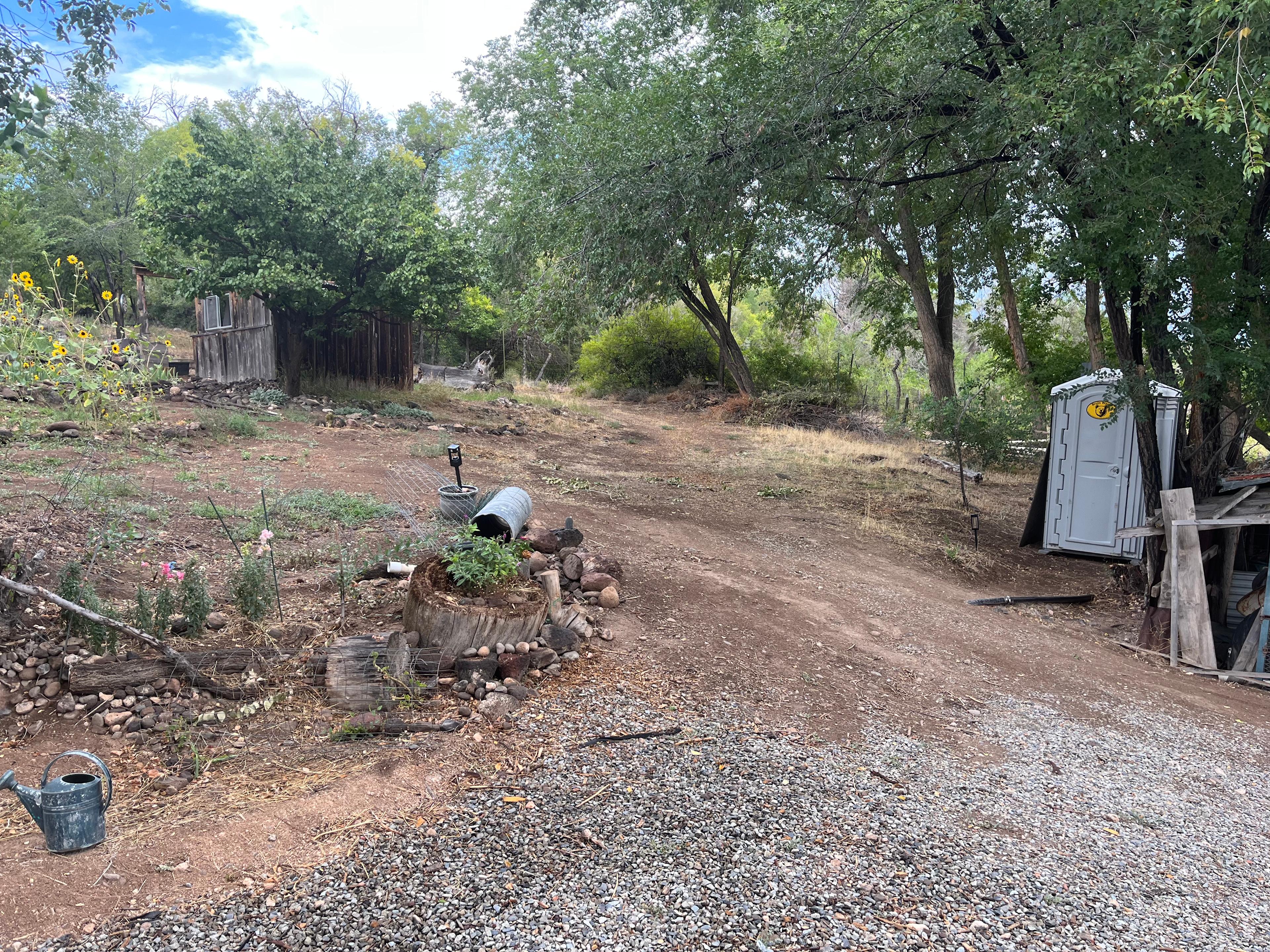 This is looking uphill from the communal cookhouse to The Shack.  The portapotty is on the right and The Shack is on the left.  The deck is on the north side, so it is not visible in this photo.