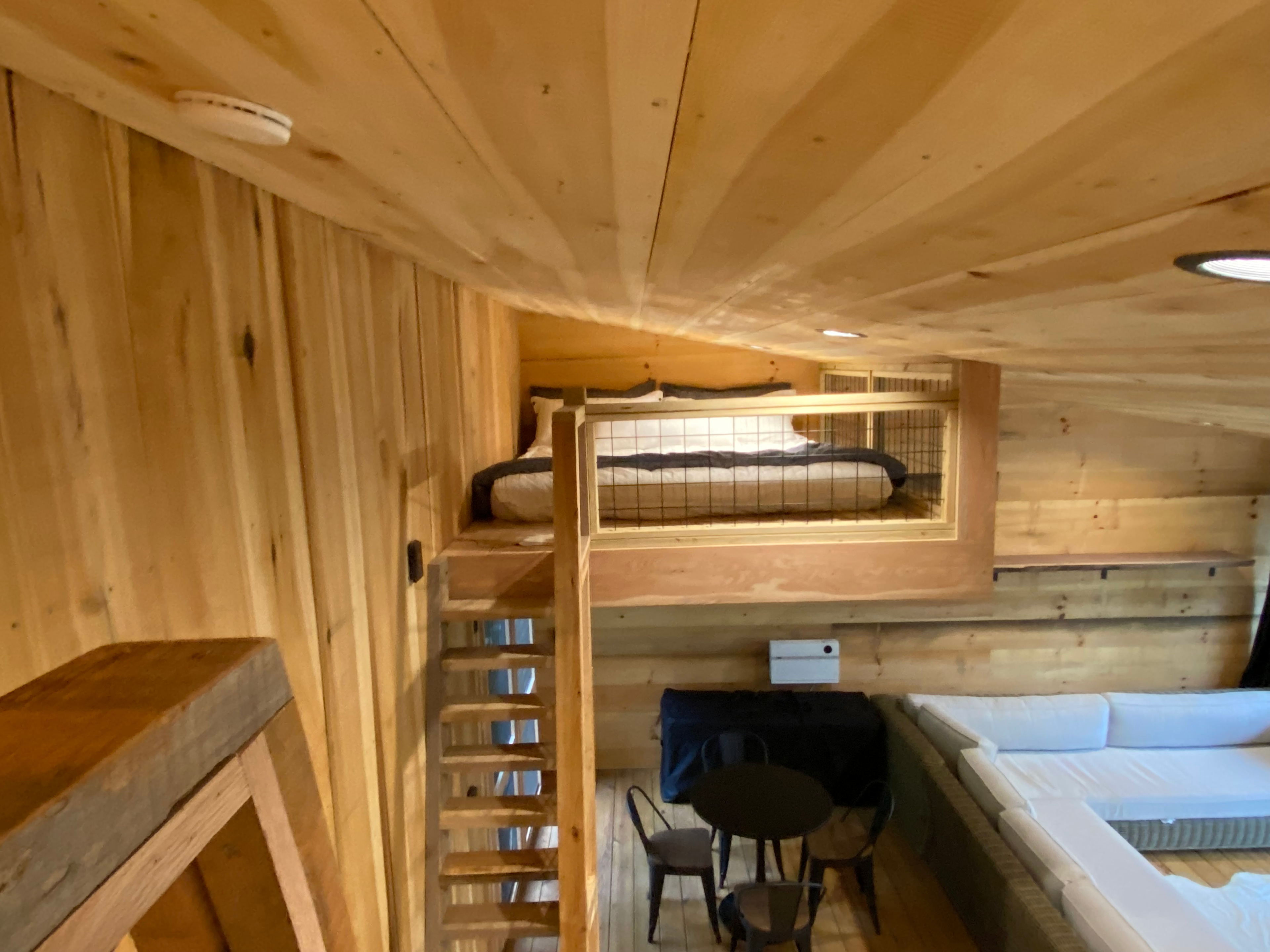 King bed in the loft area with luxurious and cozy bedding