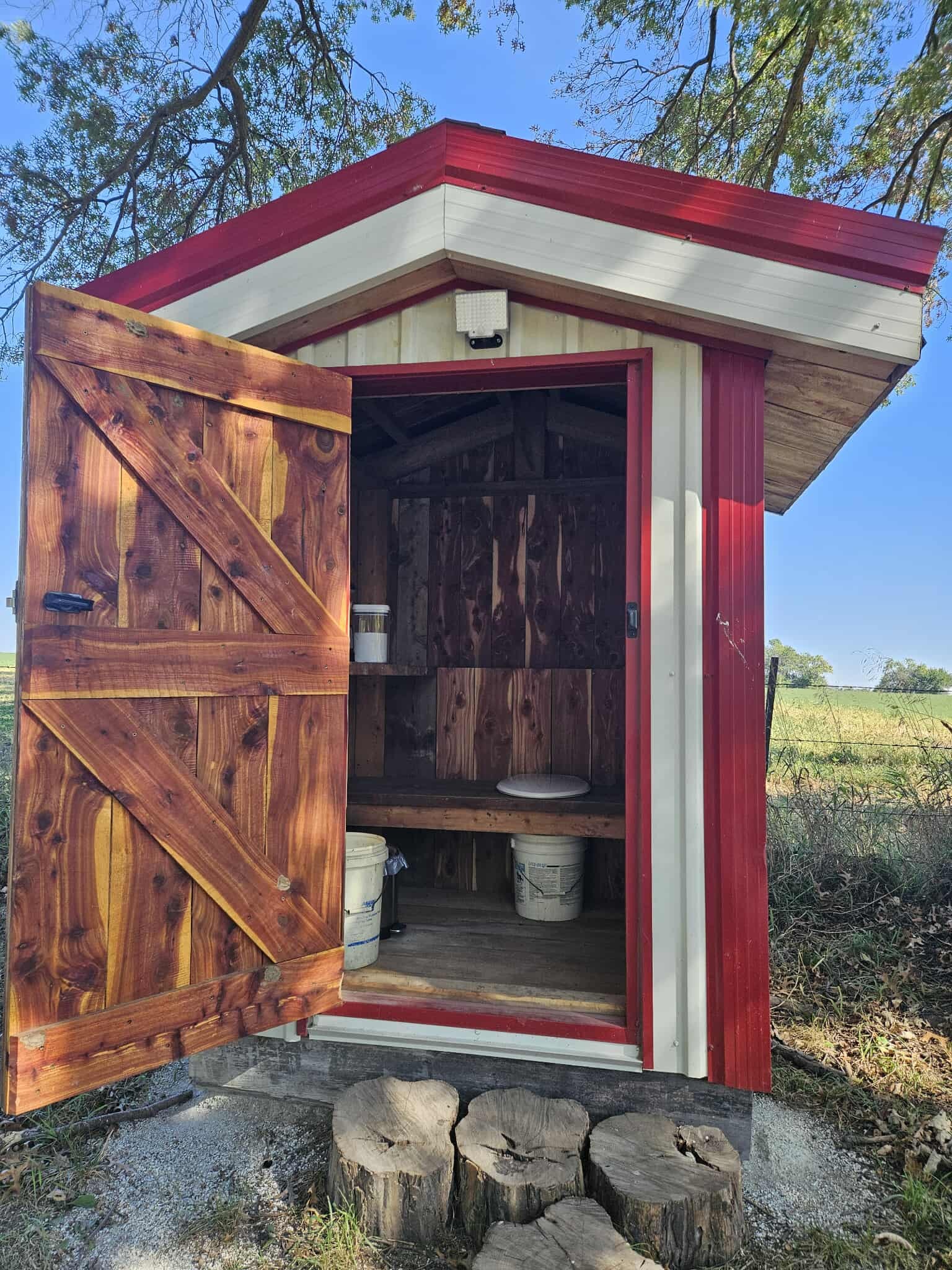 Inside the outhouse.  There is a lantern.  But you may want to bring one too.