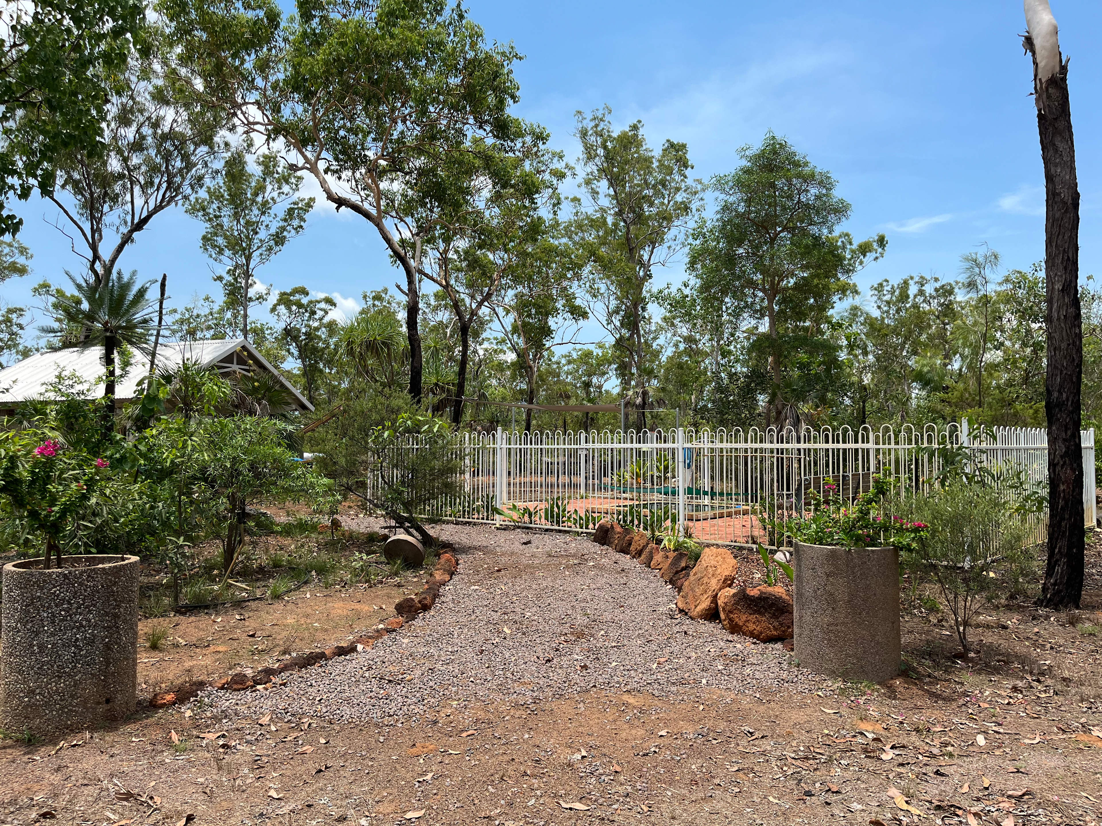 Entry into the center hub. Fully irrigated gardens, with communal kitchen, fire pit, ablution block and fire pit.
