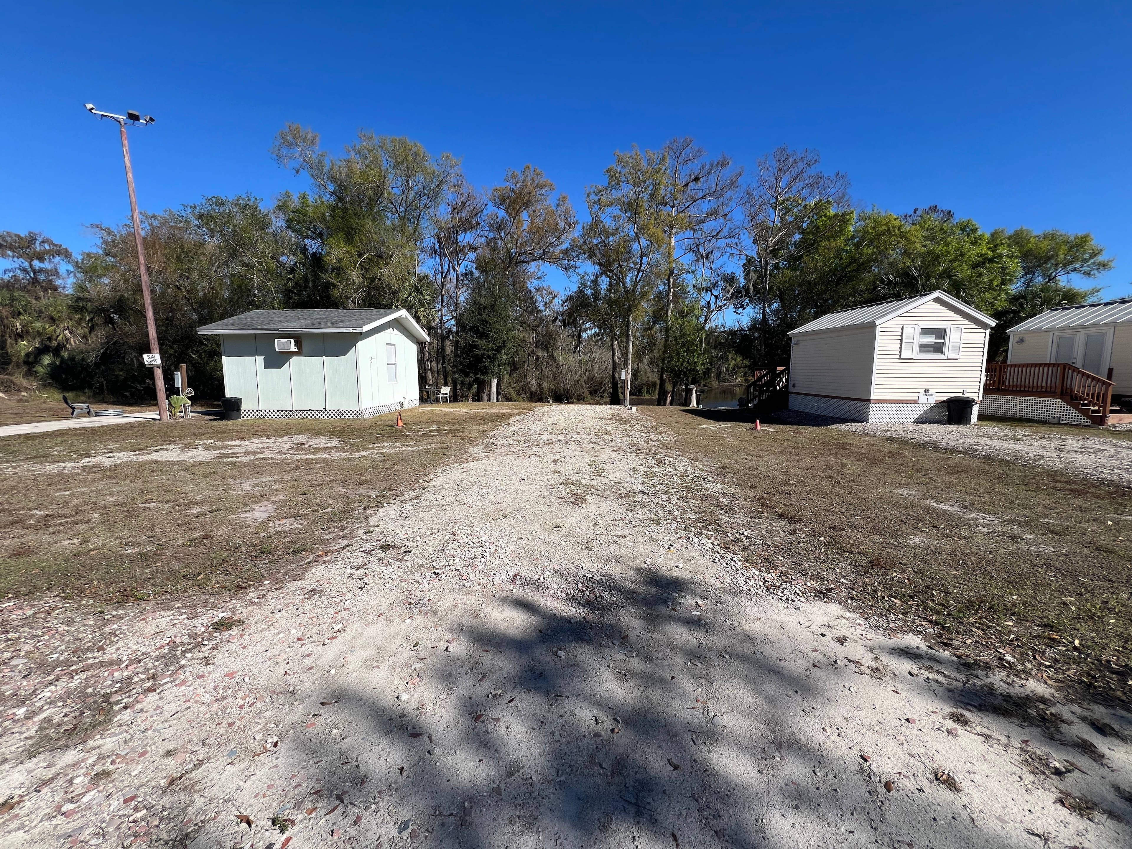 RV site is located on the water between two seasonal air bnb rentals. Site is crushed gravel 