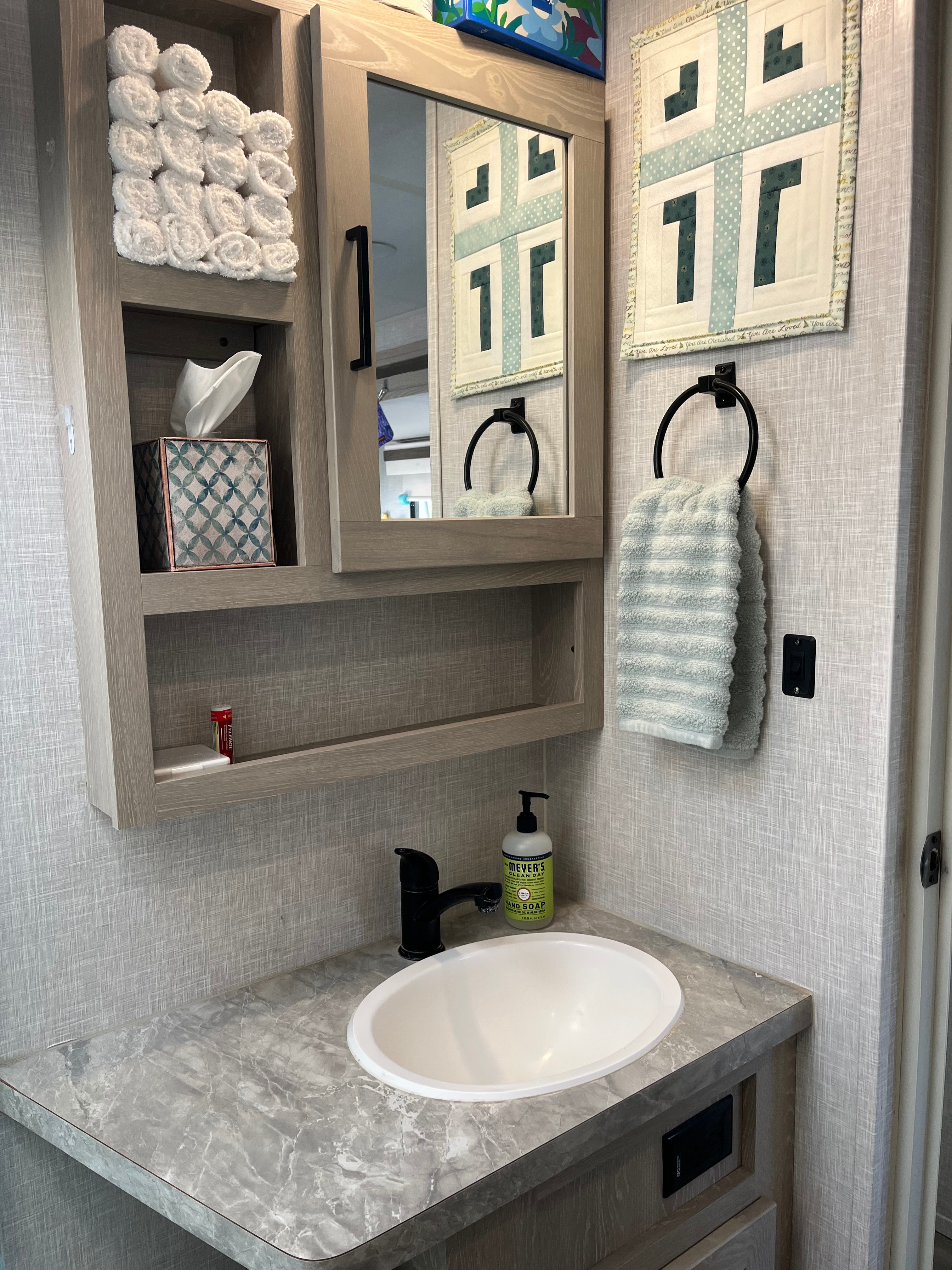 Full bath with ample storage space in linen closet and medicine cabinet