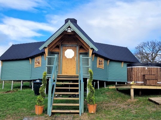 Entrance to the lodge and hot tub (before landscaping and patio for firepit)