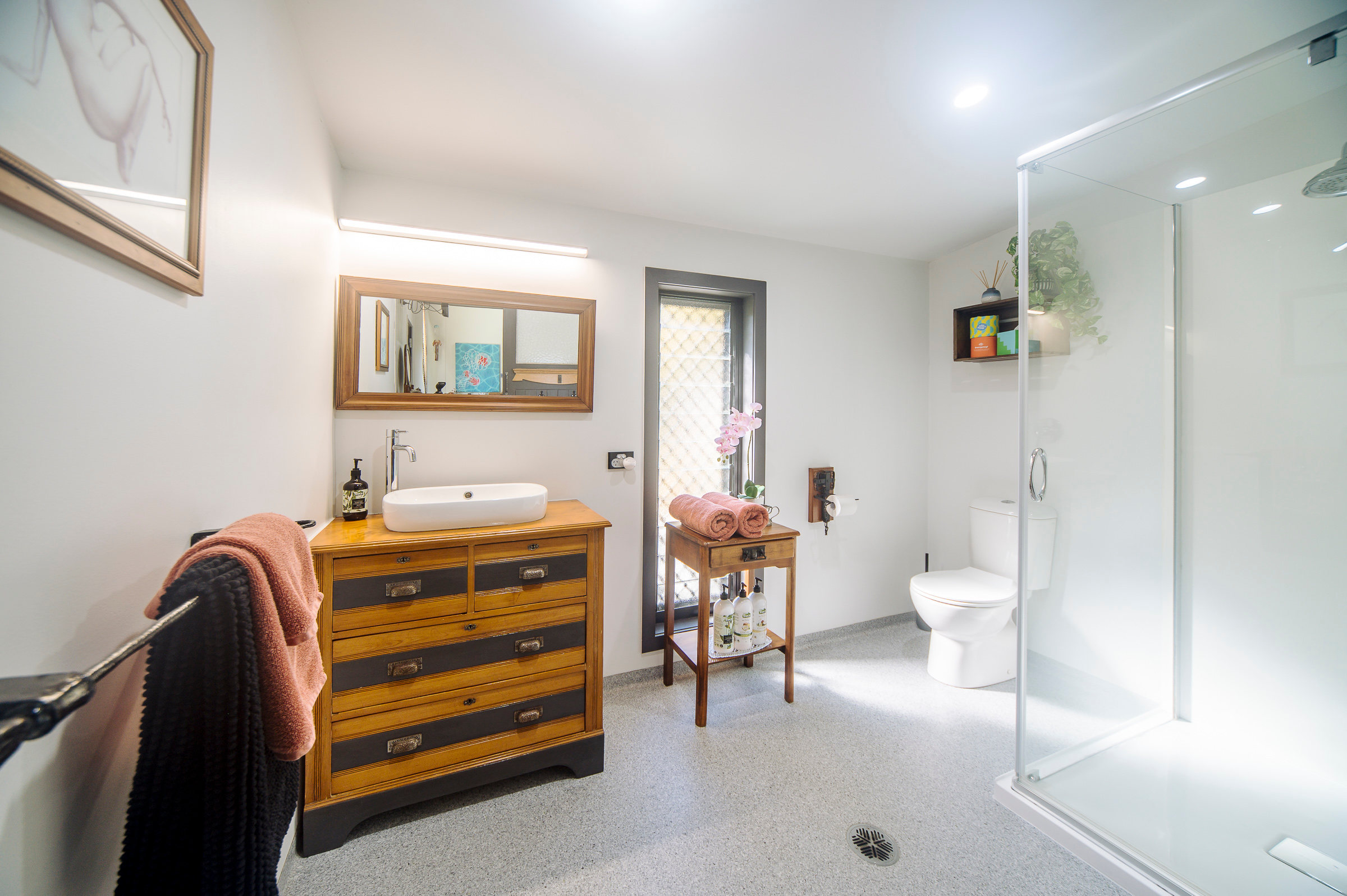The space features a private ensuite complete with toilet, shower, body wash, shampoo, conditioner, and fresh towels provided for your convenience.