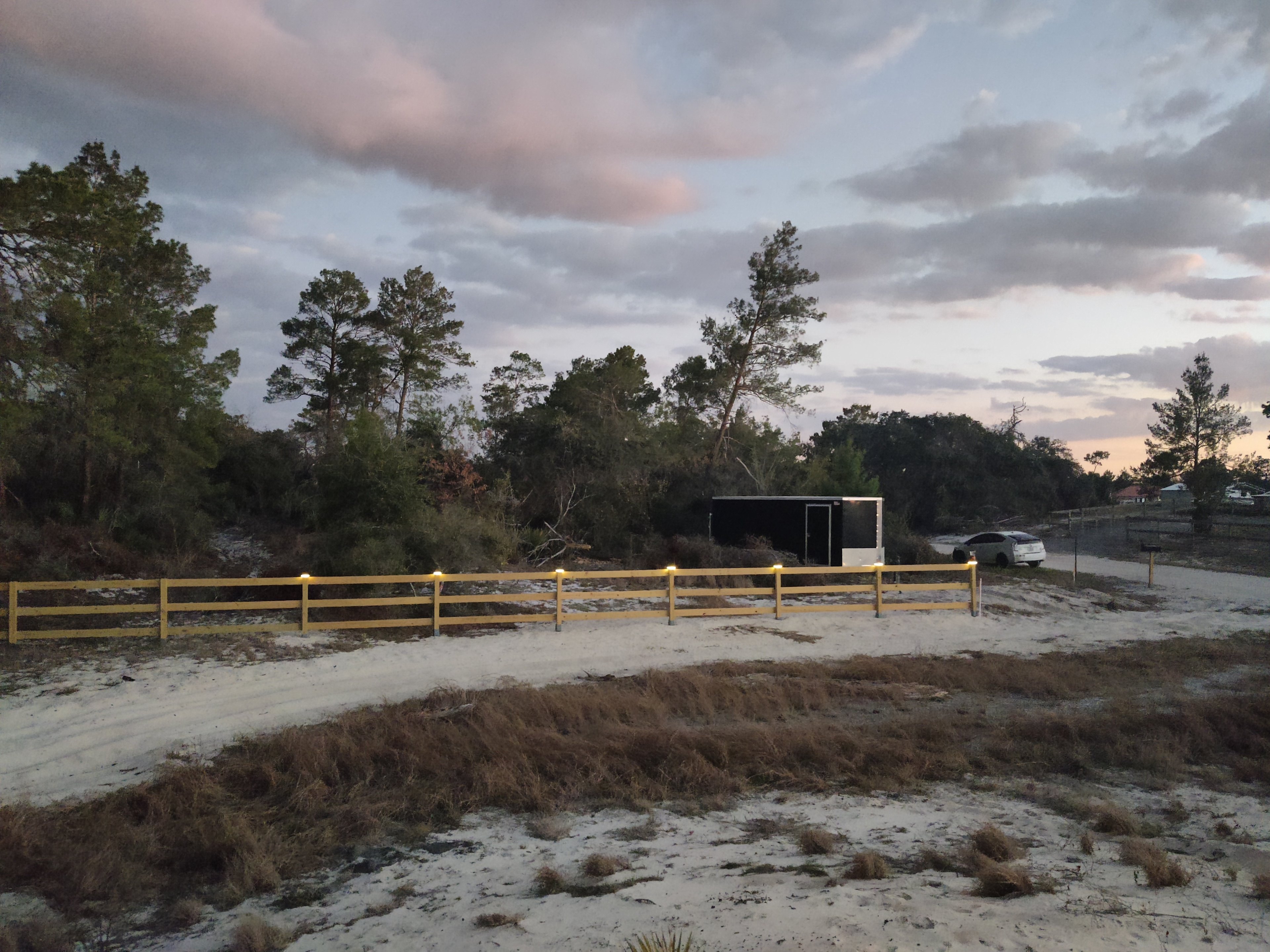 Easily spot the site by the wooden 3-rail fence with welcoming lights along the posts.