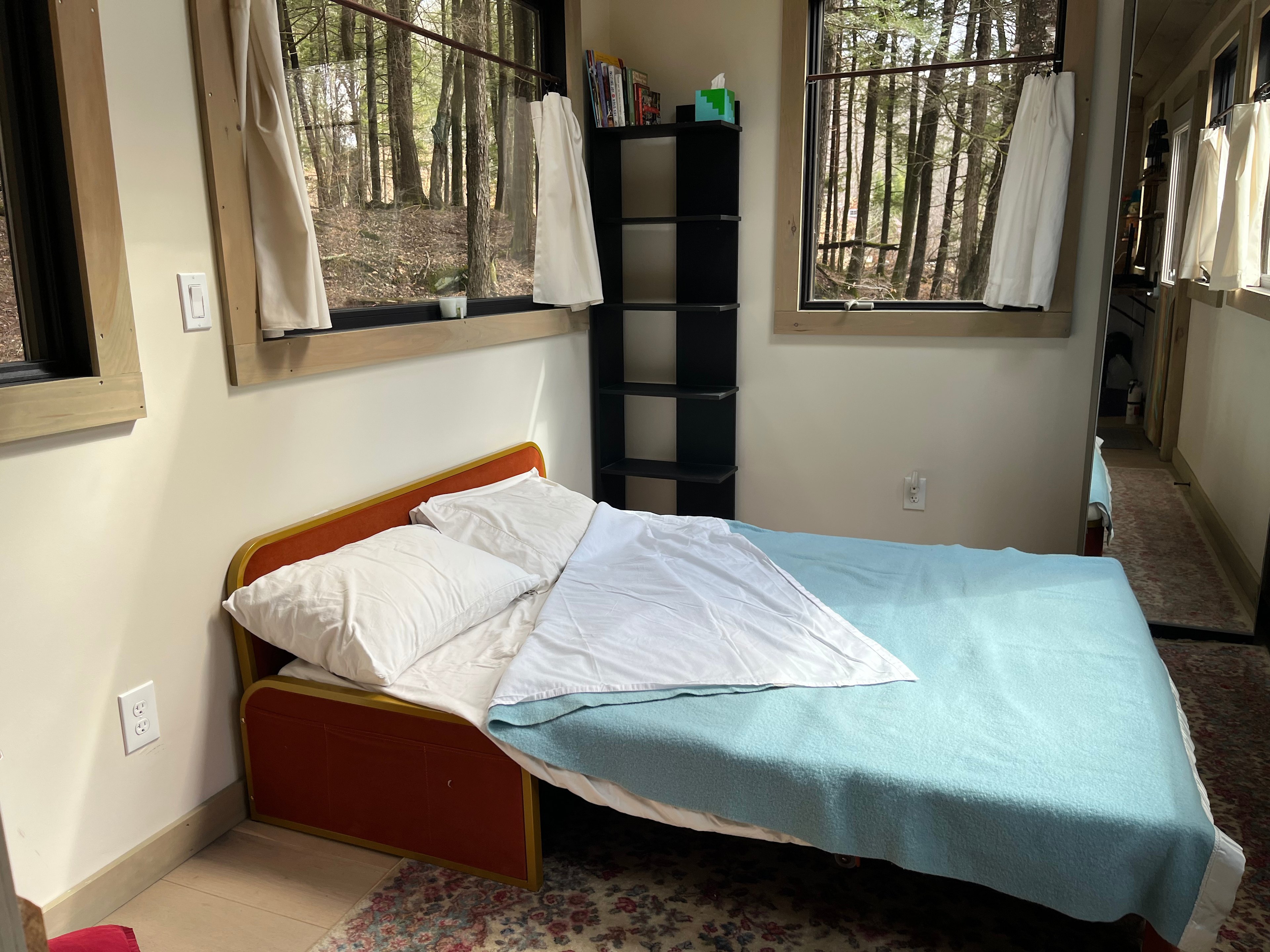 The fold-out double bed is easy to manage and comfortable.  There are plenty of shelves and a small closet for your clothing and other gear.  Natural light pours in 14 windows+skylights.  A mini-split keeps the temperature just as you like it.