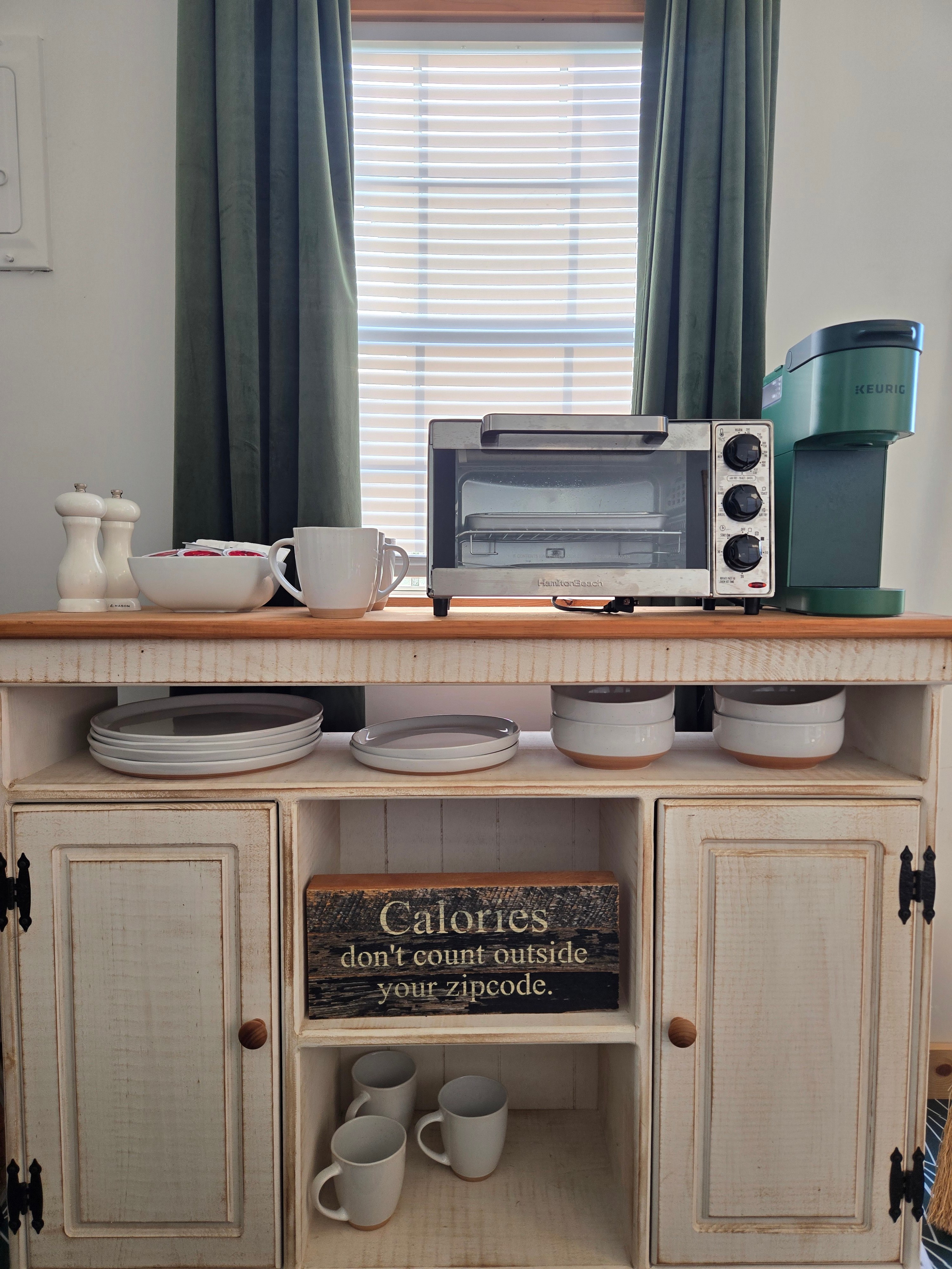 Keurig, stainless steel air fryer, salt and pepper, stoneware plates, bowls, mugs, linen napkins, silverware, organic coffee and tea