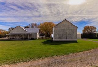 The back of our heritage-style wooden barn. Barn swallows love this spot — keep an eye out!