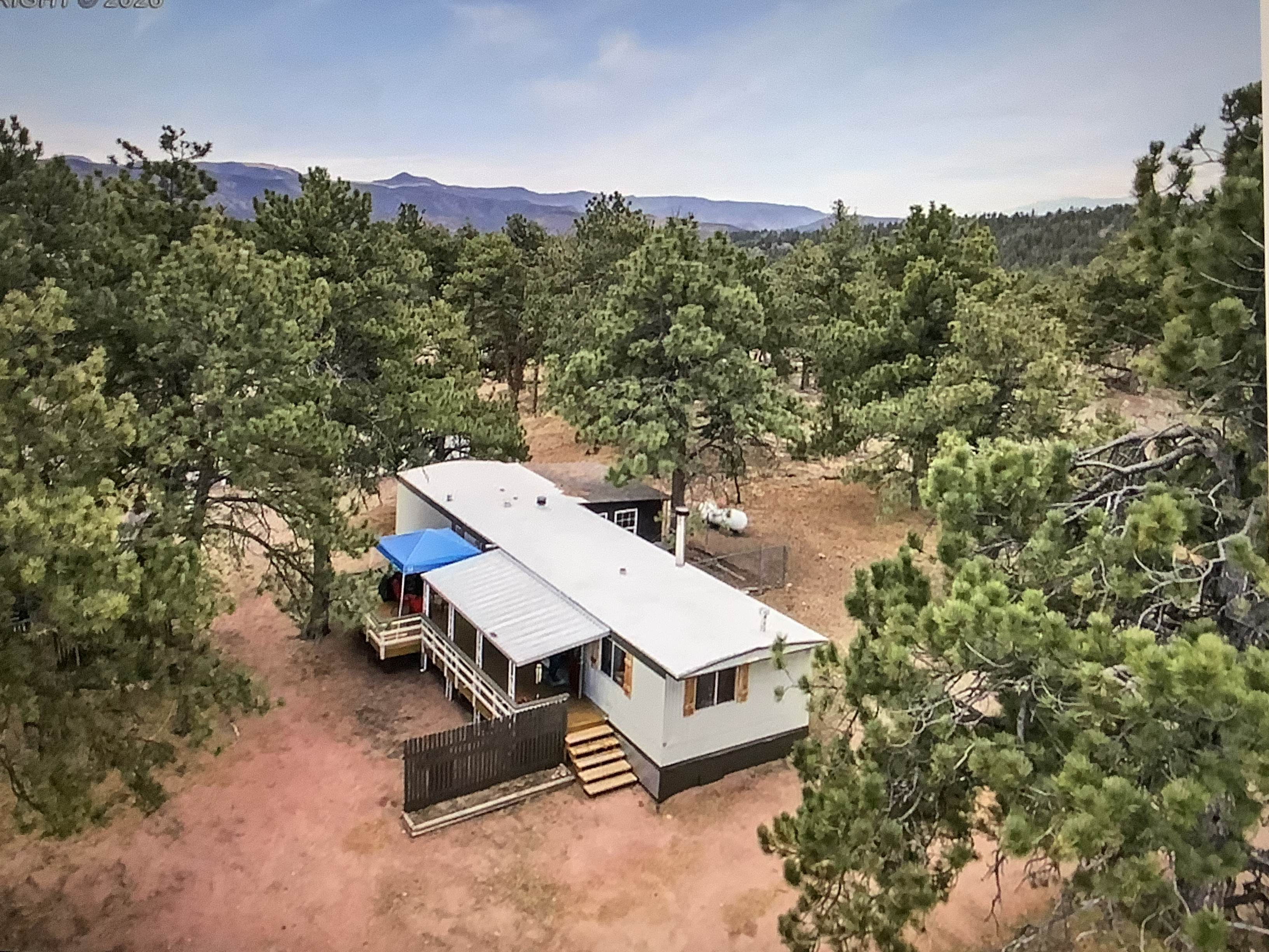 Aerial view of mobile cabin in woods.