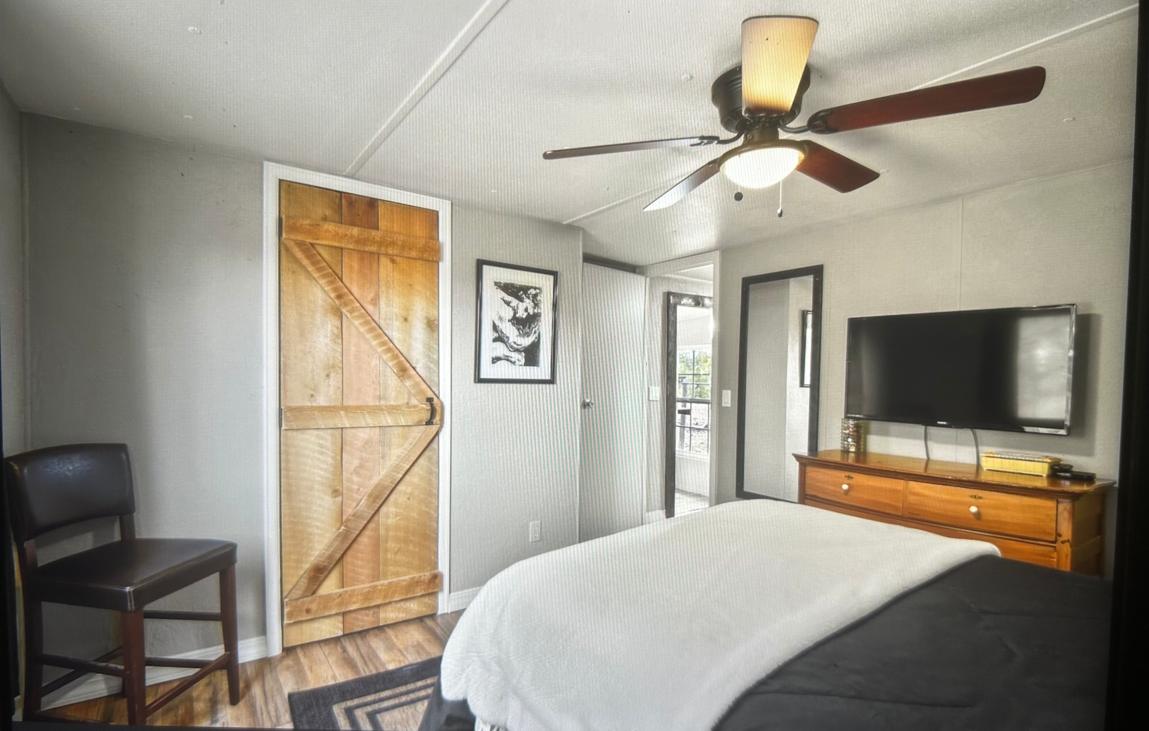 The larger bedroom with heat and ceiling fan. Secretly, it’s the only room with a television using Internet and Roku.