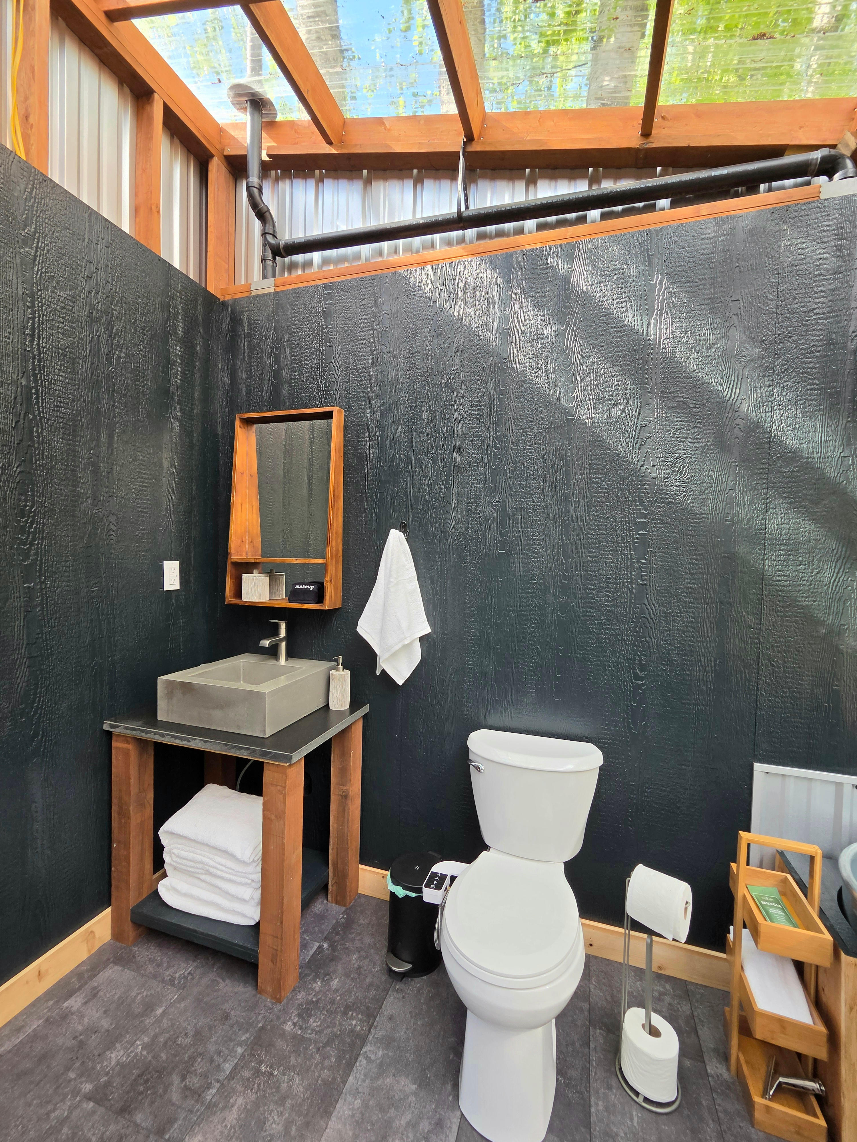 Enjoy the ultimate comfort in the woods with your own private ensuite bathroom featuring modern flushing toilet, hot and cold running water.  