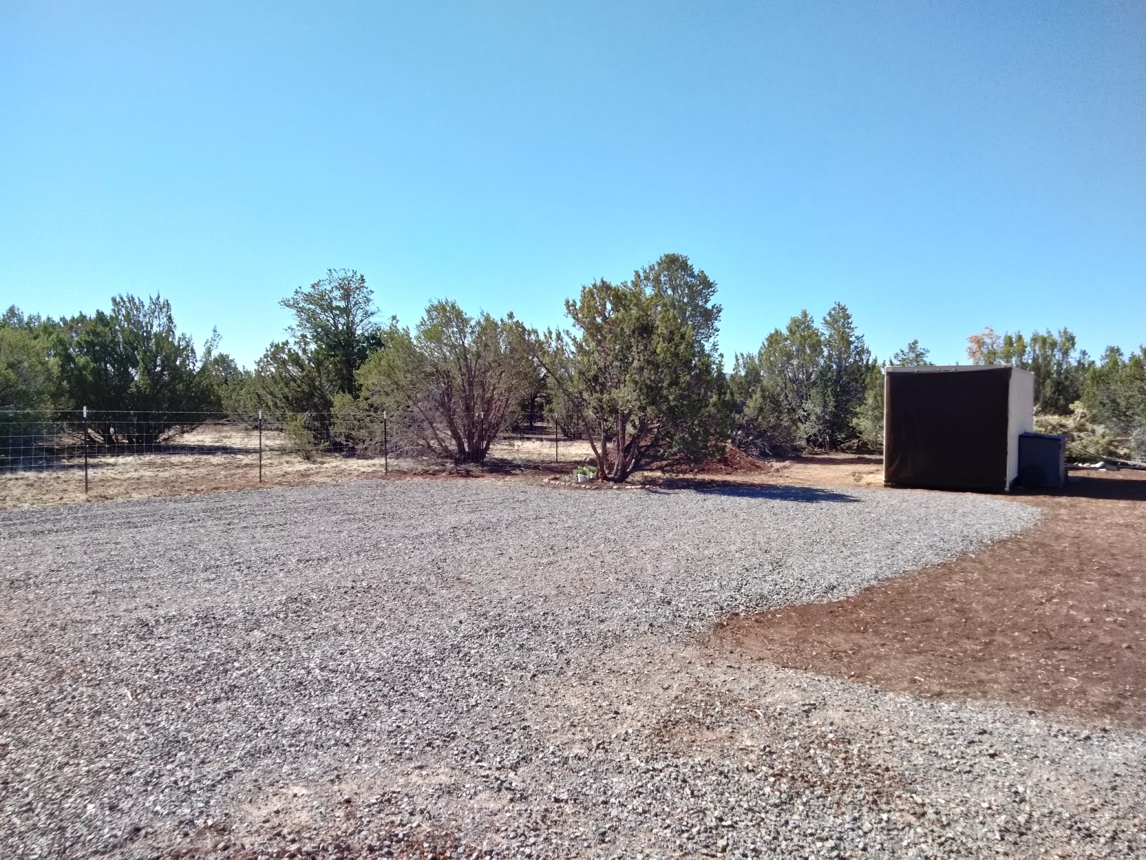 Huge gravel pad accommodates two RVs with ample space between; West Landing Site near the fence and East Landing Site in front of the Storage Pod. East landing site accommodates larger RVs.