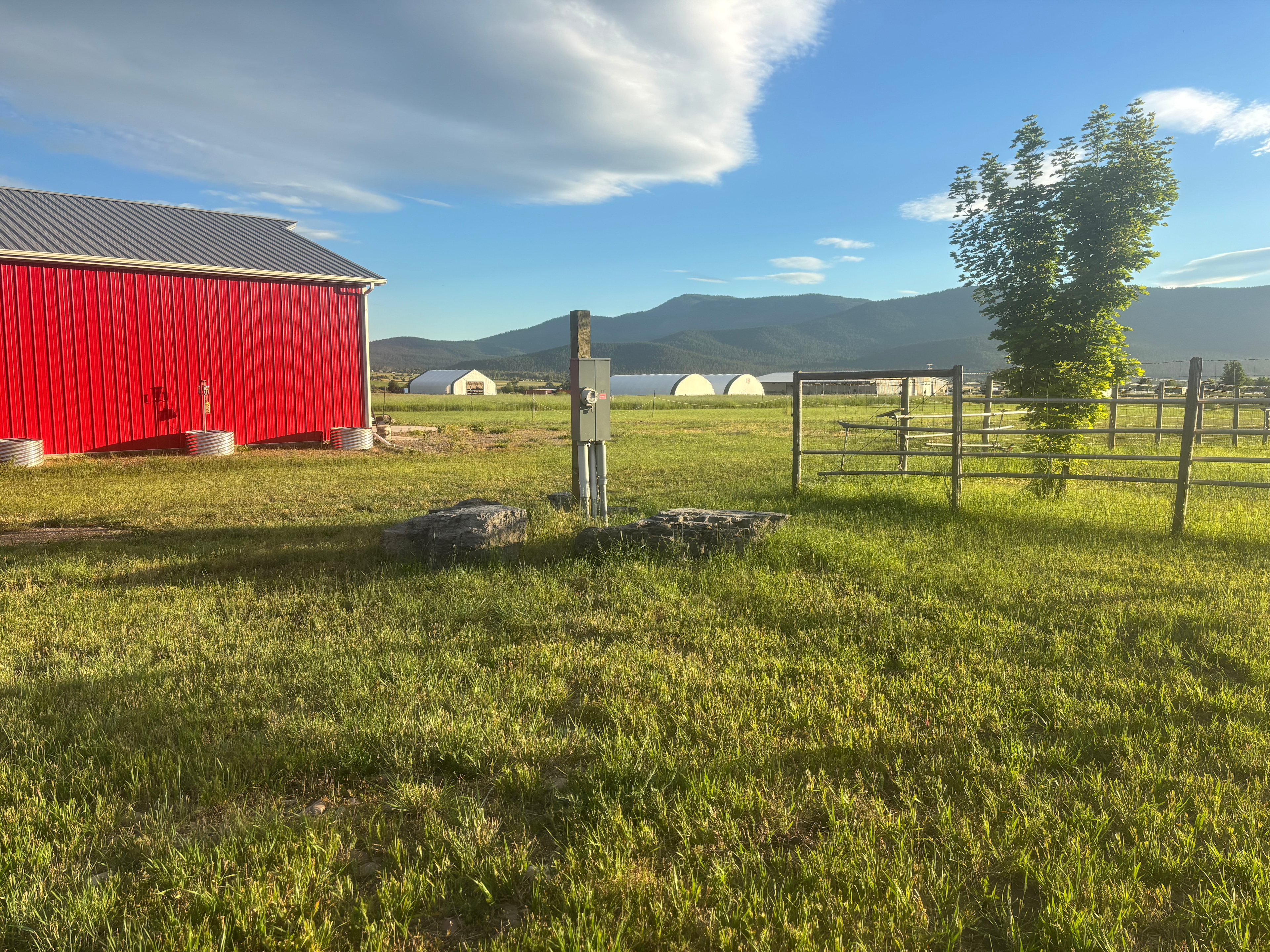 You may park to the right of these rocks as the electoral hook up is on this electoral pole.   Please do not park in the drive way area along side of the red barn. 