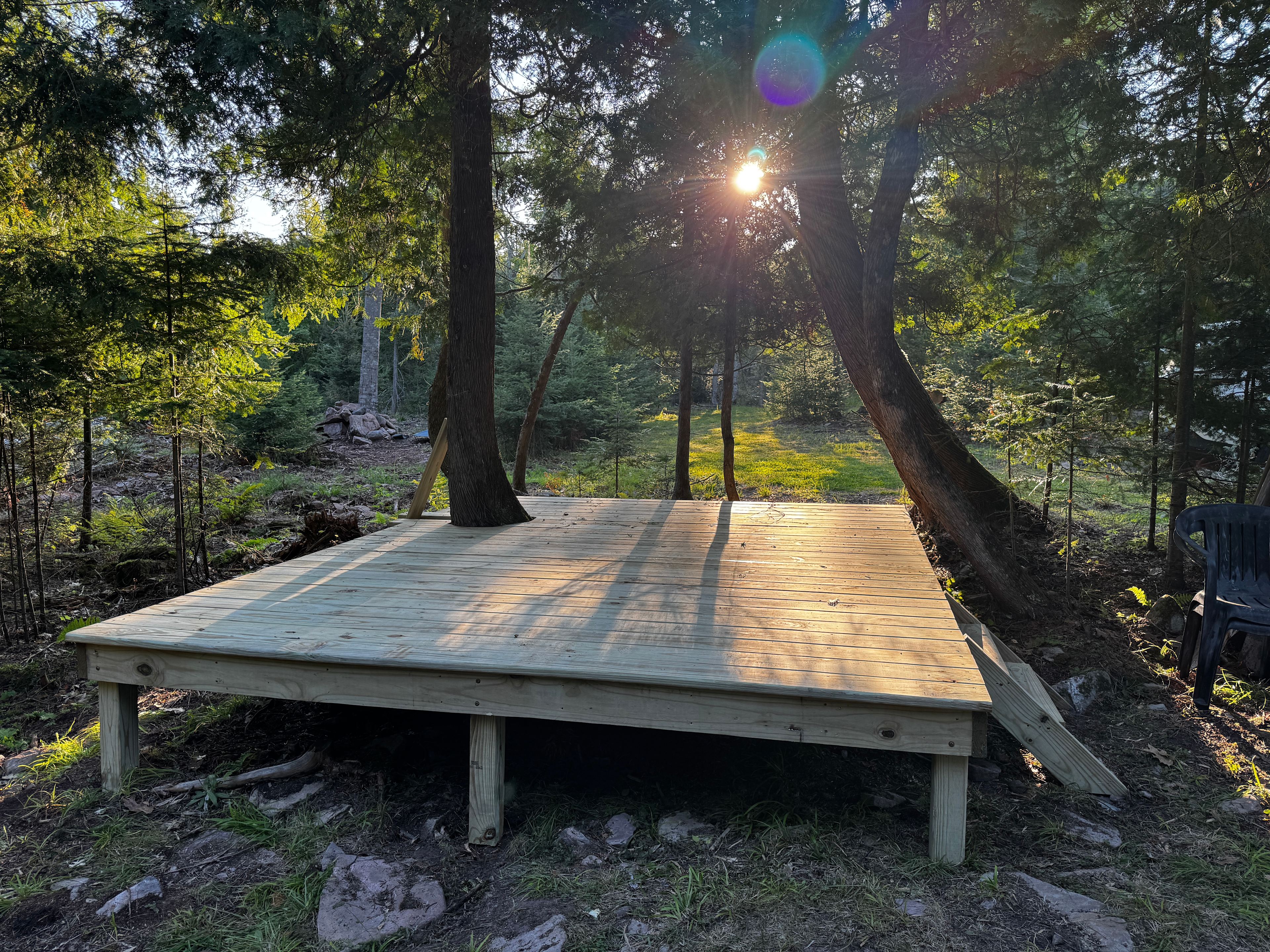 An above ground platform that can accommodate a smaller tent or seating for relaxing while maintaining a campfire.