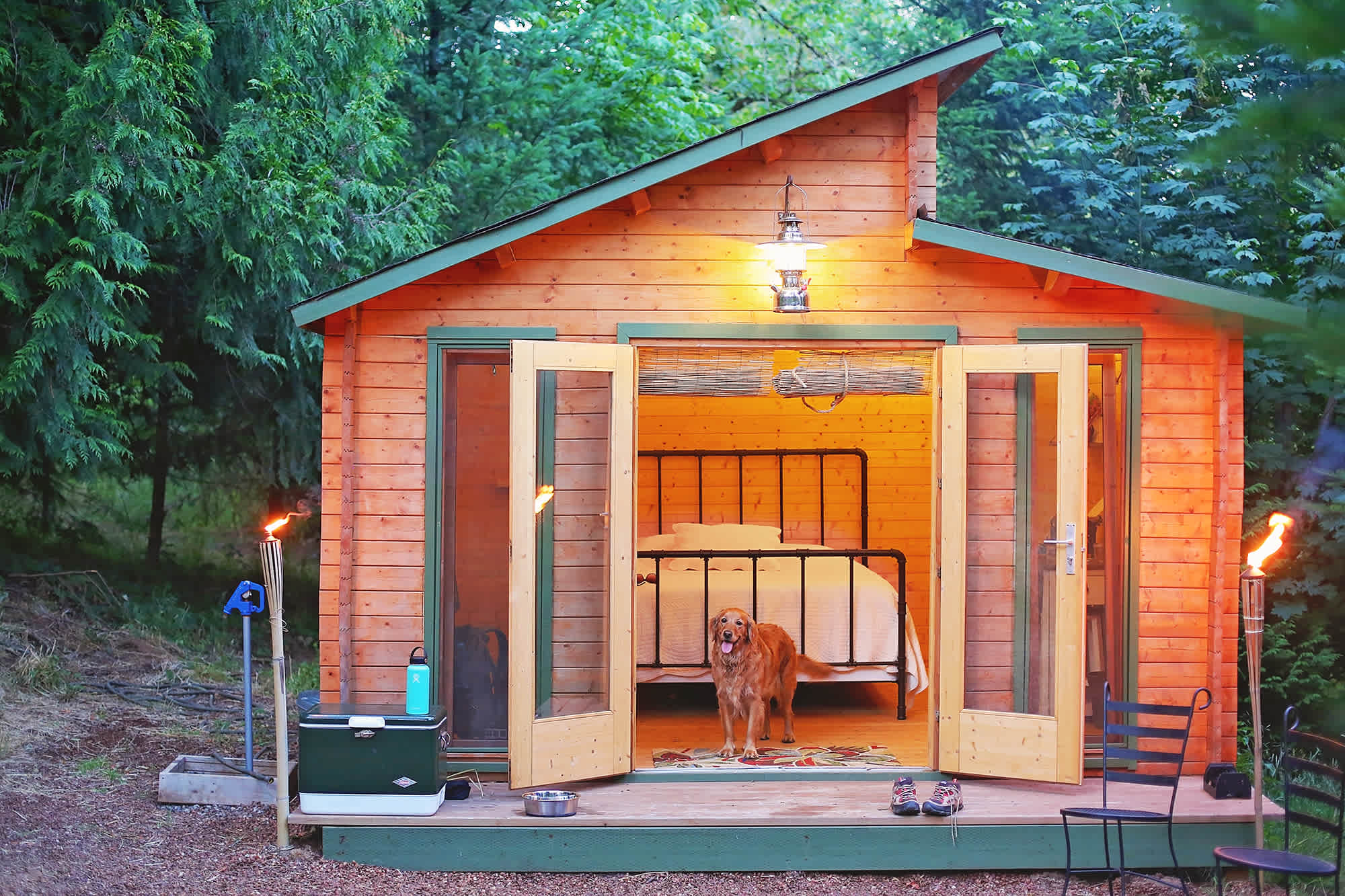 Tiki torches light the outside and fairy lights light the inside of the cabin.