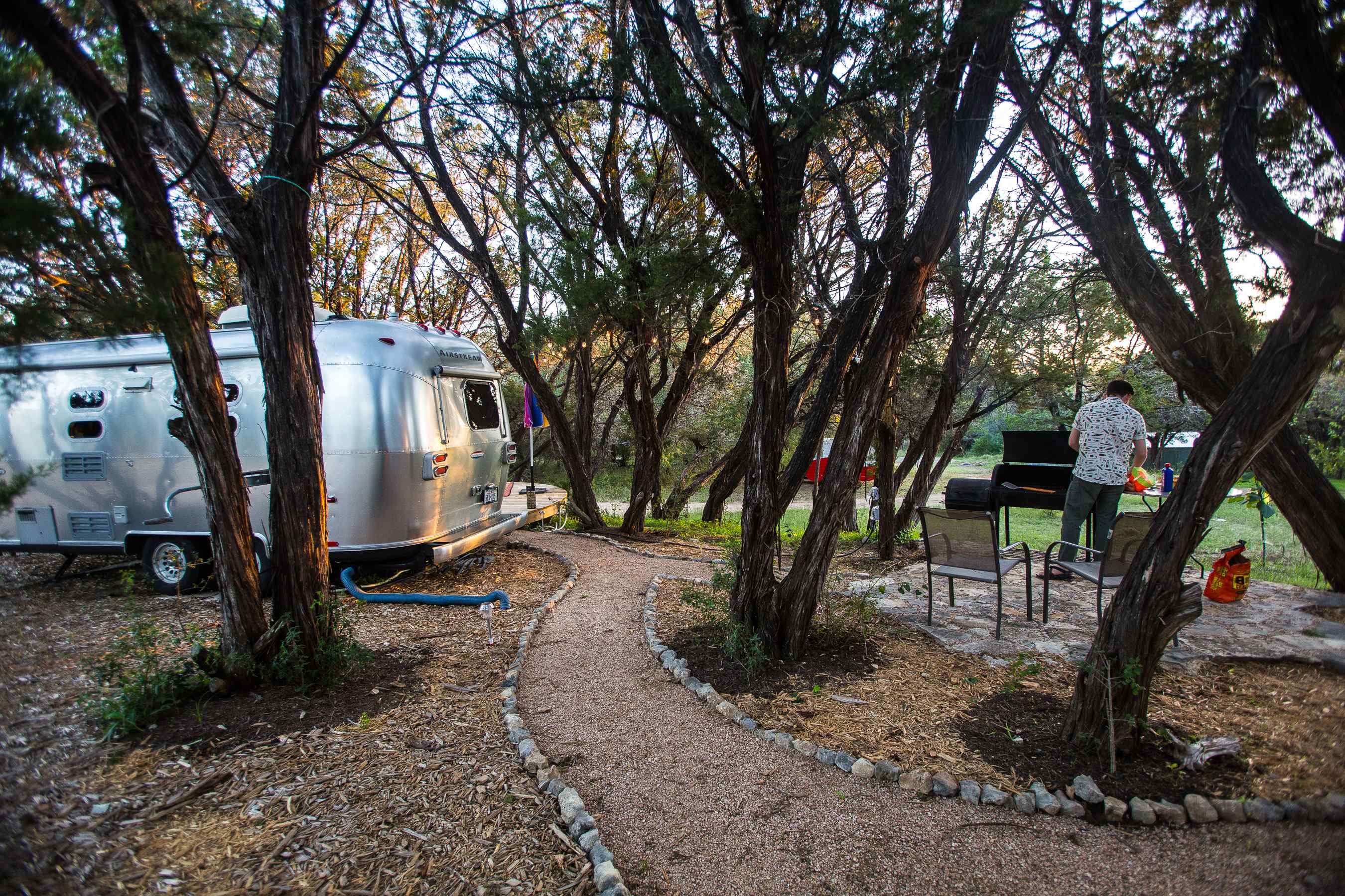 Prepping dinner at the grill that's set up right next to the airstream.