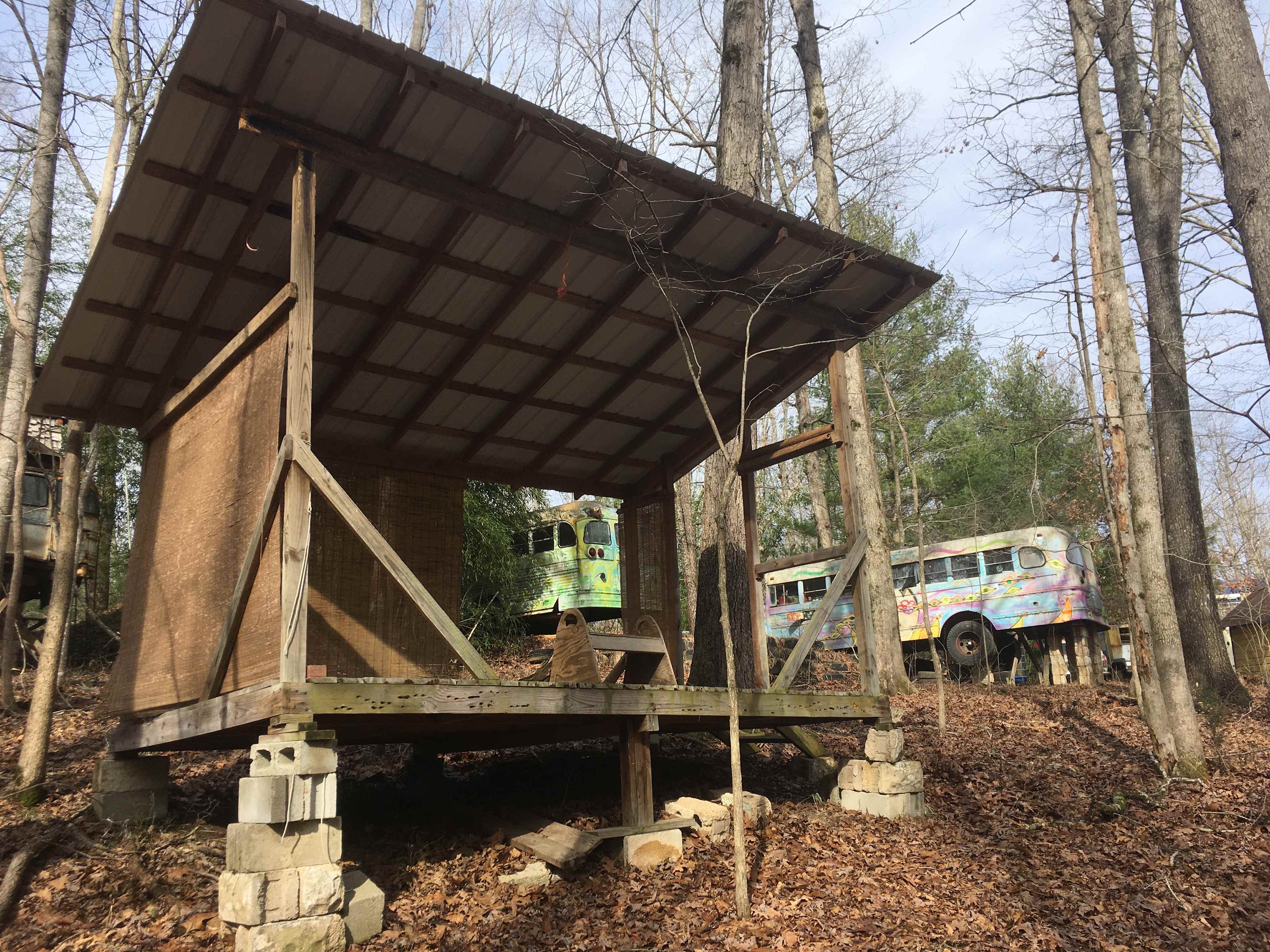 A nice tin roof keeps the downpour off of your gear. The Old School Bus in the background is also part of our site, and might be occupied by campers as well! 