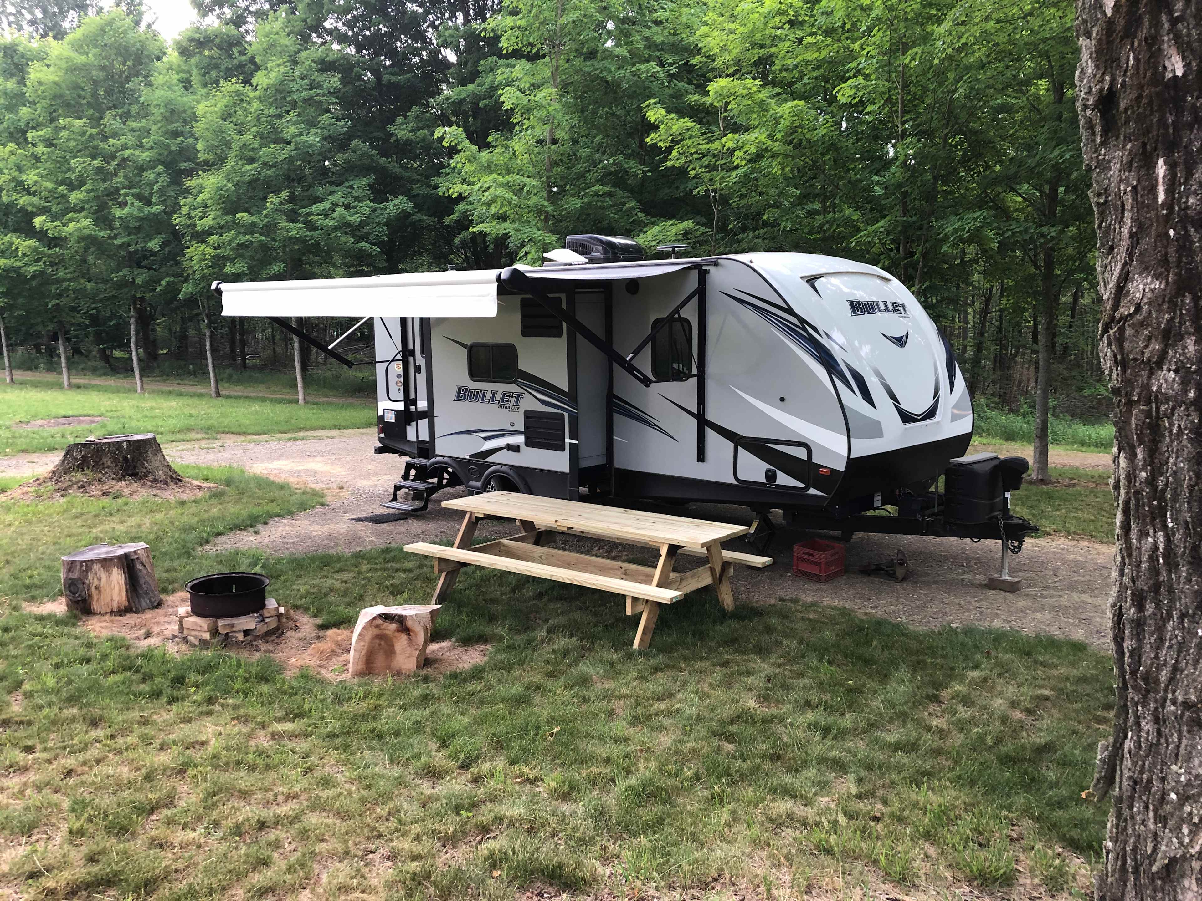 This is camp site #1. It is gravel and level surrounded by mowed grass. The camper is not for rent; it is set up for demonstration purpose