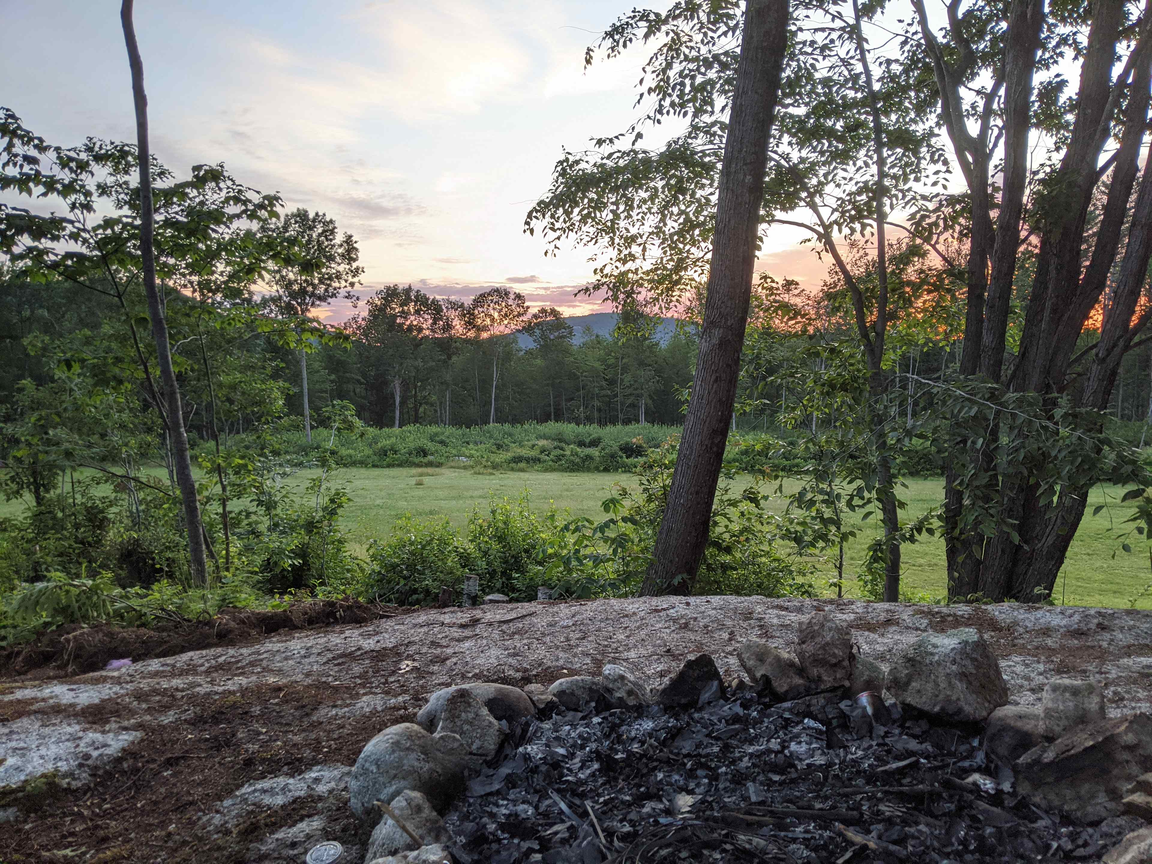Fire pit (located in the bunch of trees in the field, on a giant rock)