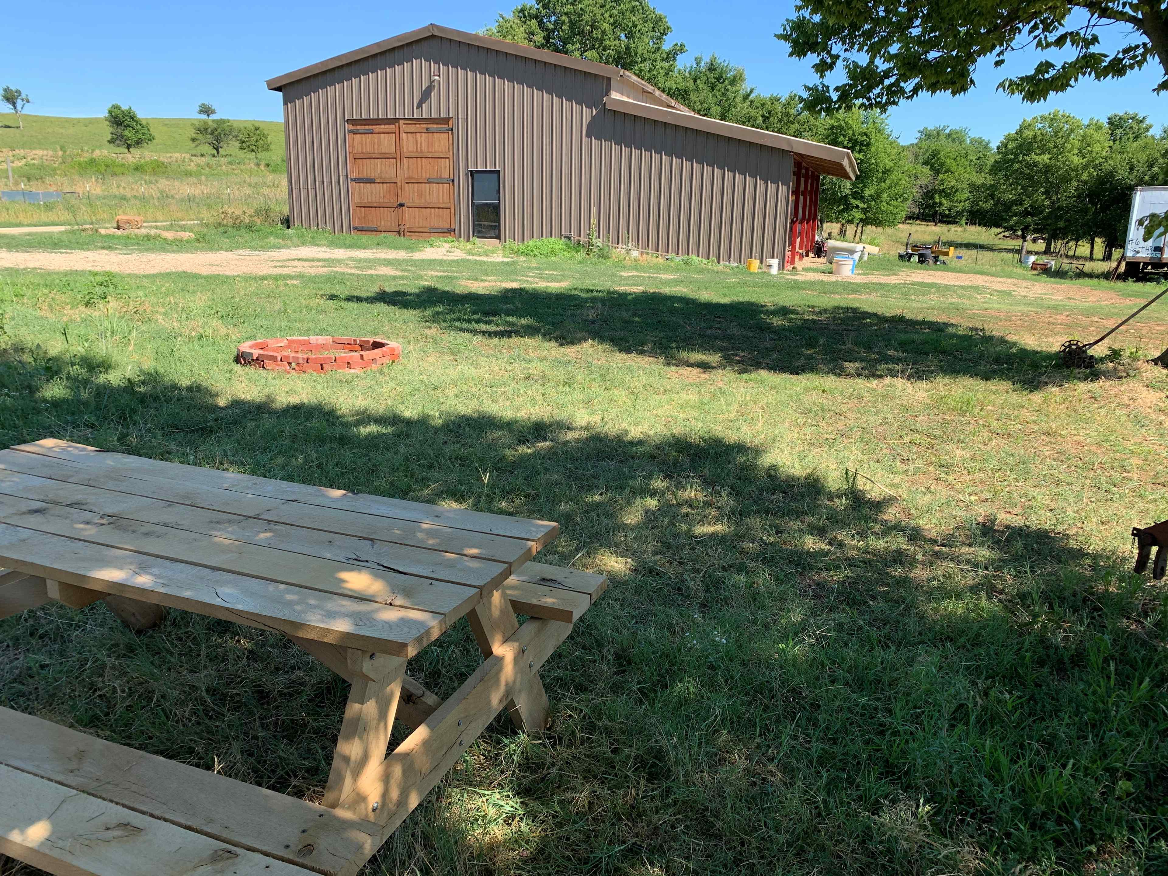 Here is the barnyard camp site including a picnic table, fire pit and shade for your tent or small camper