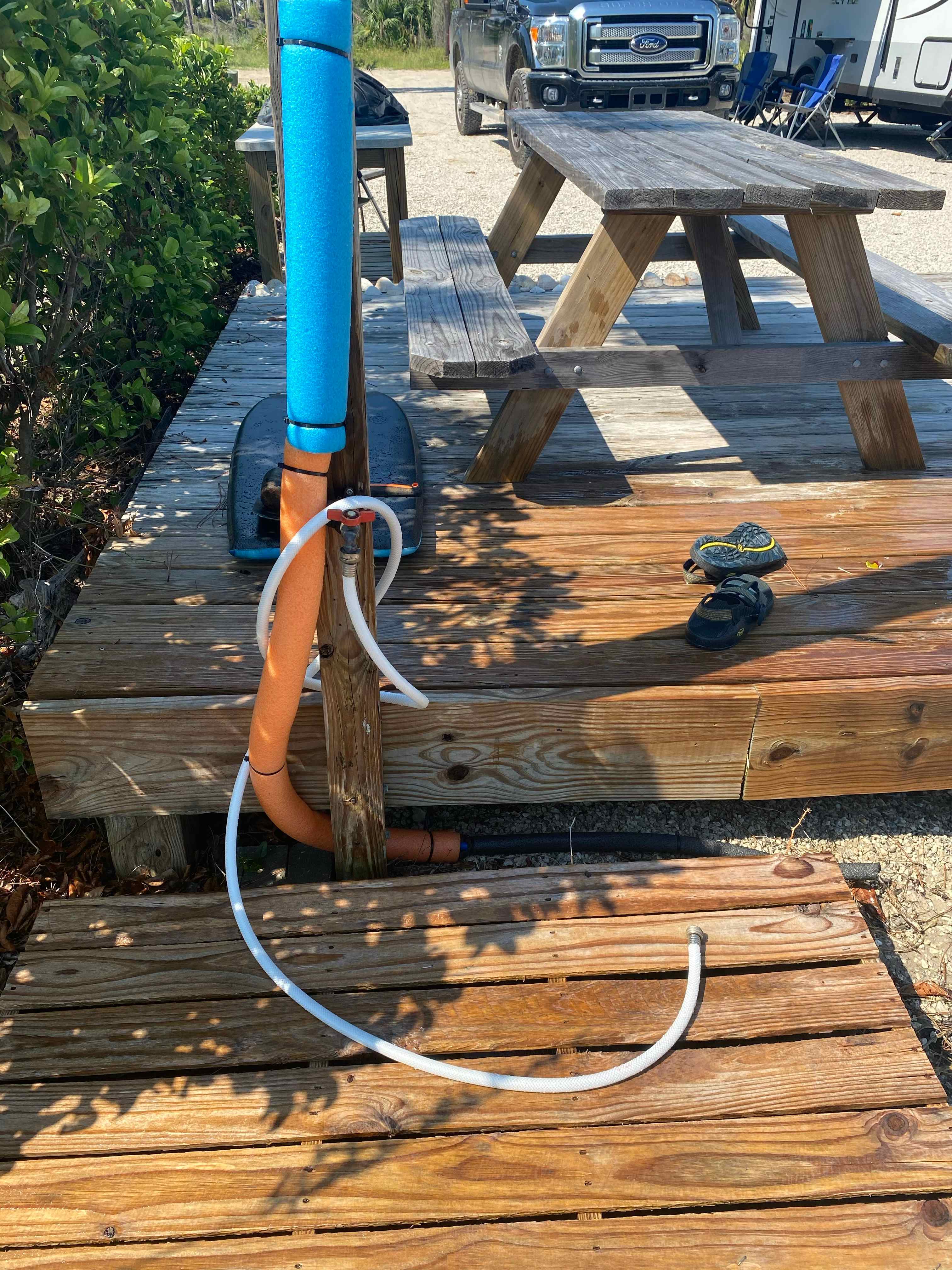 Outdoor shower plus hose for washing off sand and beach gear.