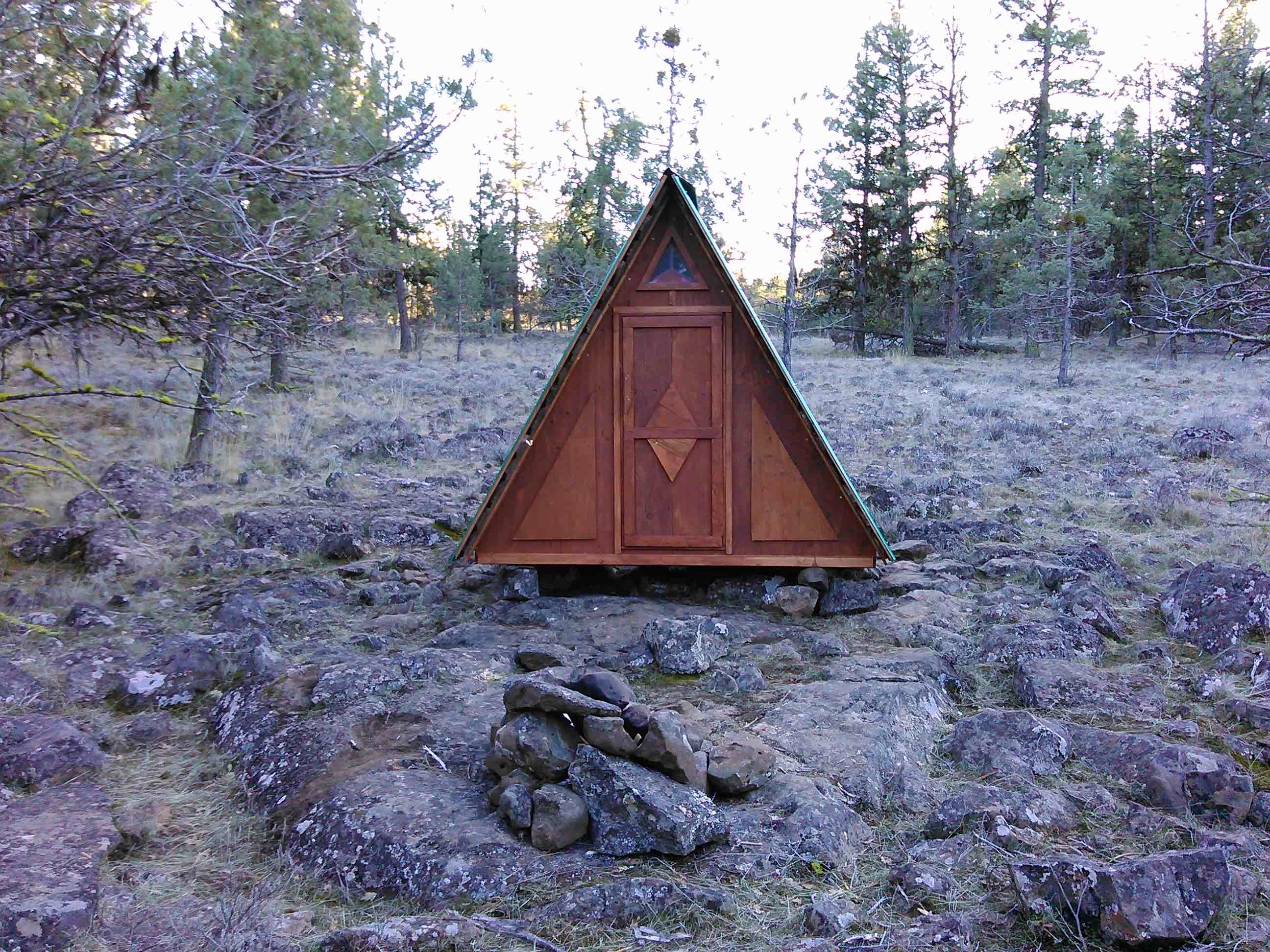 This is the "wooden tent" microcabin, about 250ft across the field from the Snugshack. An available included sleeping option for parties with more than two people.