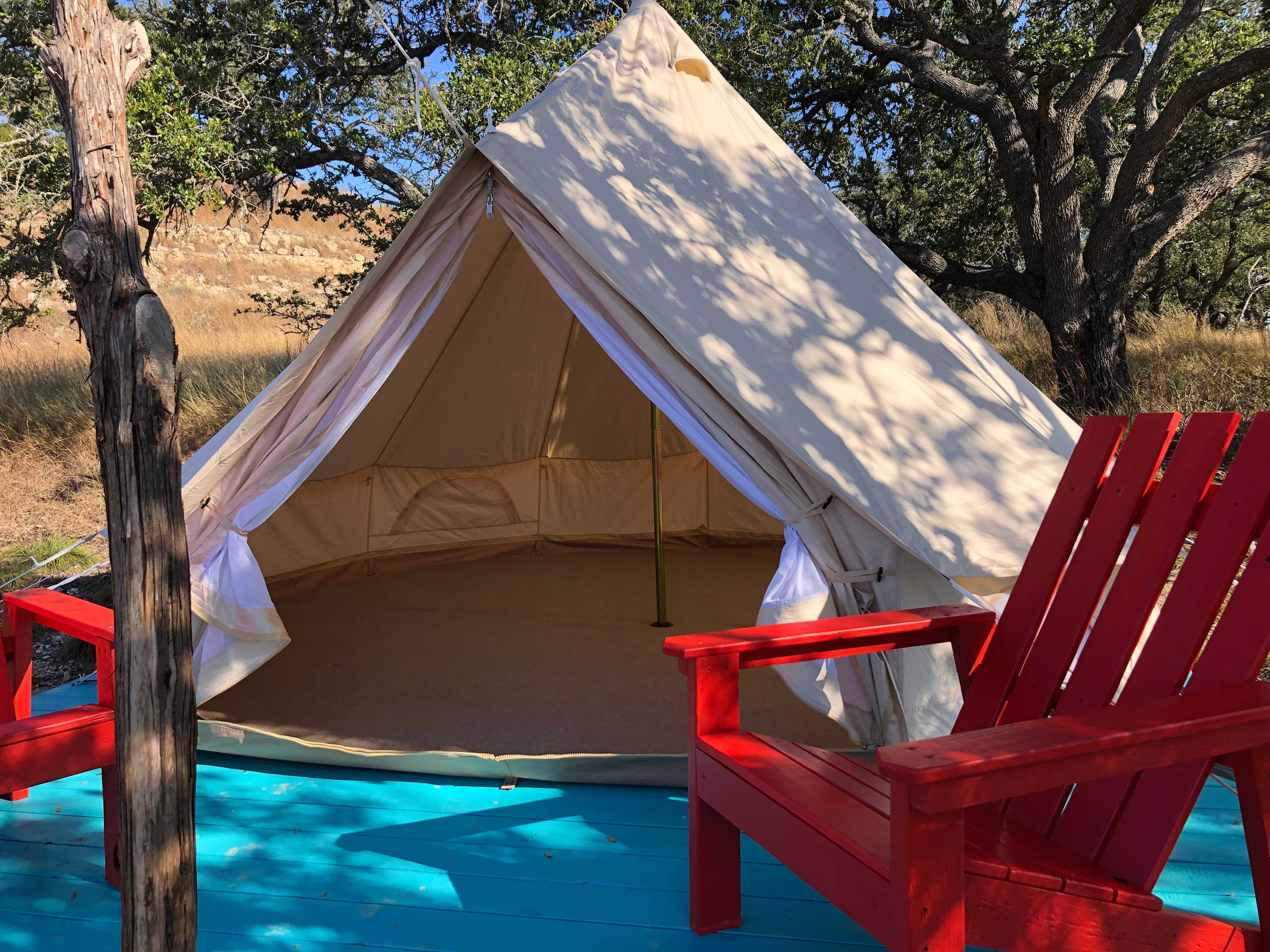 Bell tent has a large area rug on floor and plenty of room
